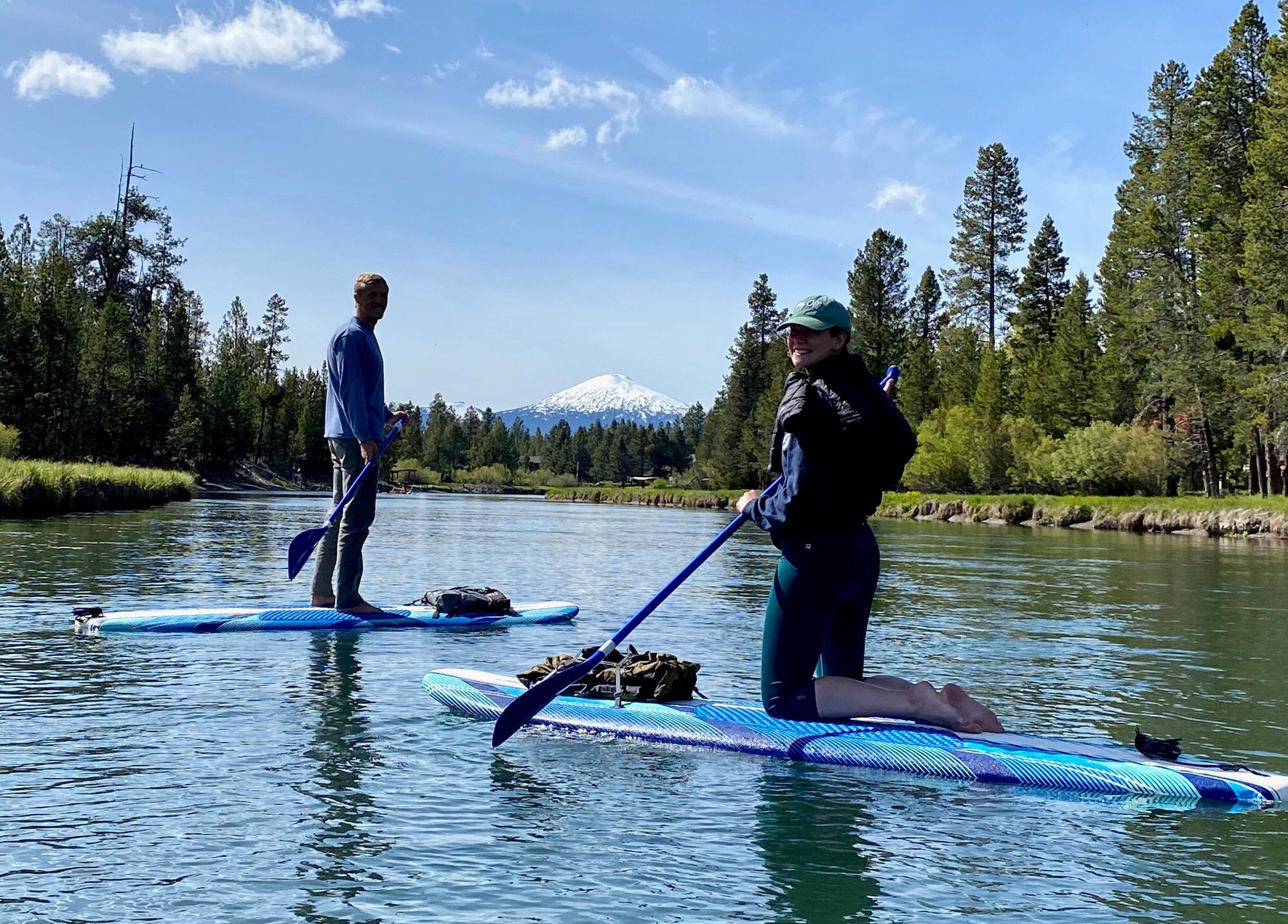 Paddle boarding with white tipped mountains.