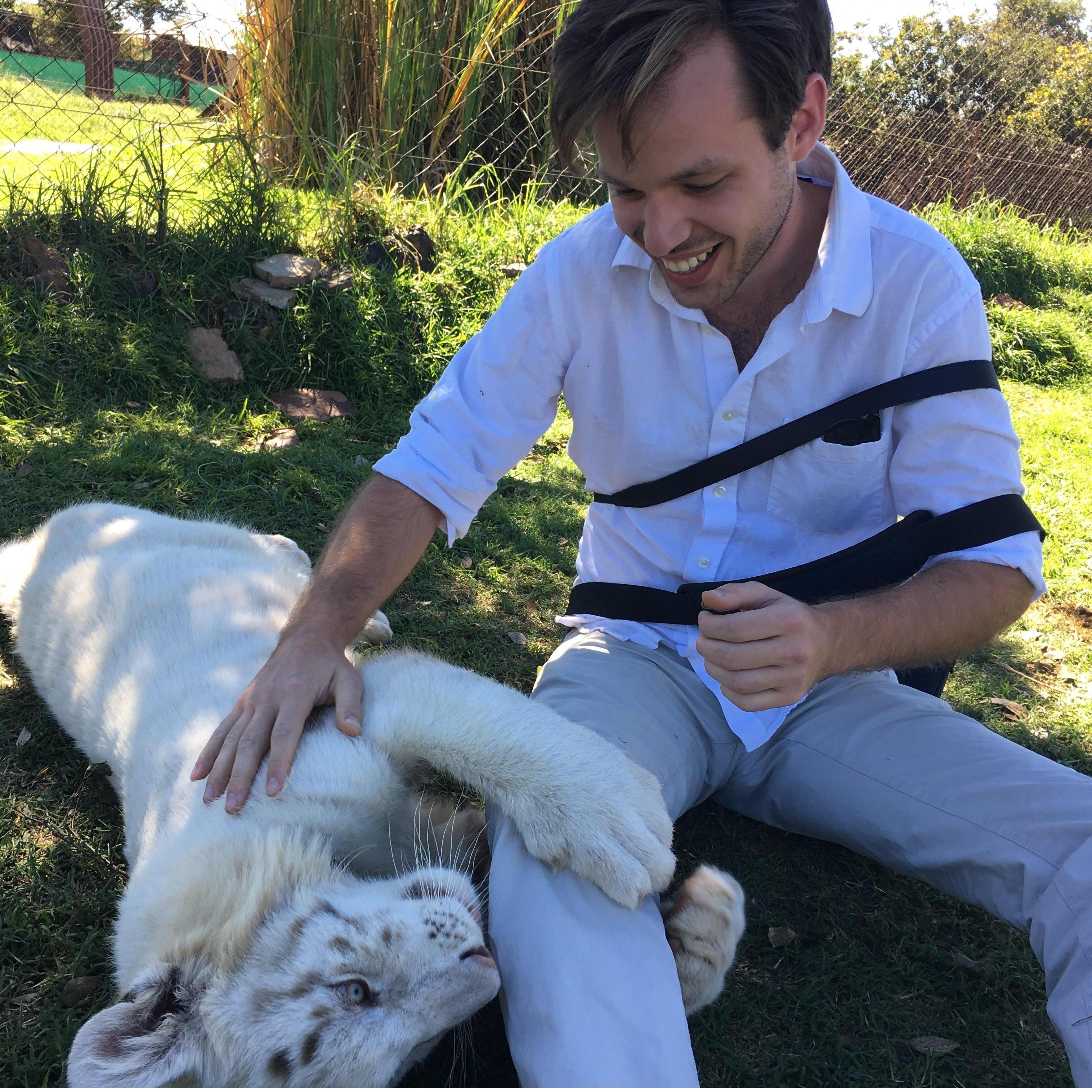 Jack petting a tiger in South Africa