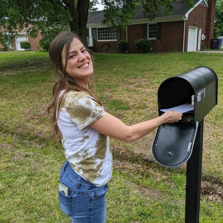 Julia mailing off their first mortgage payment for their first home