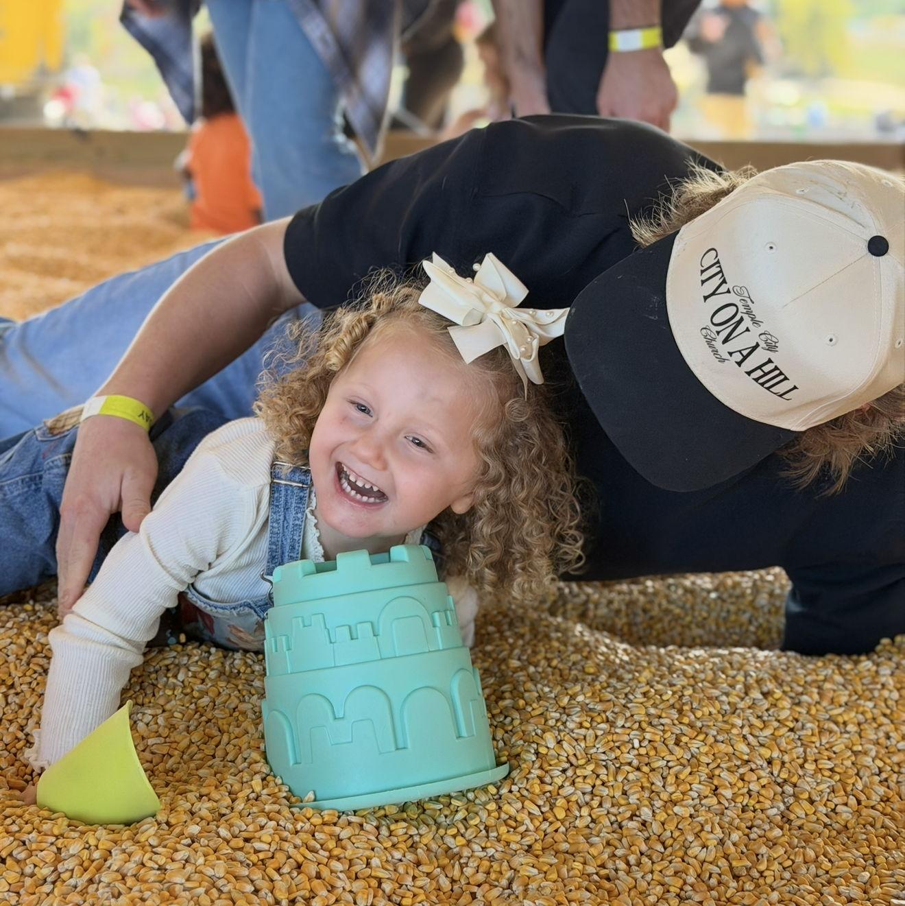 Being silly at the fall festival in the corn pit
