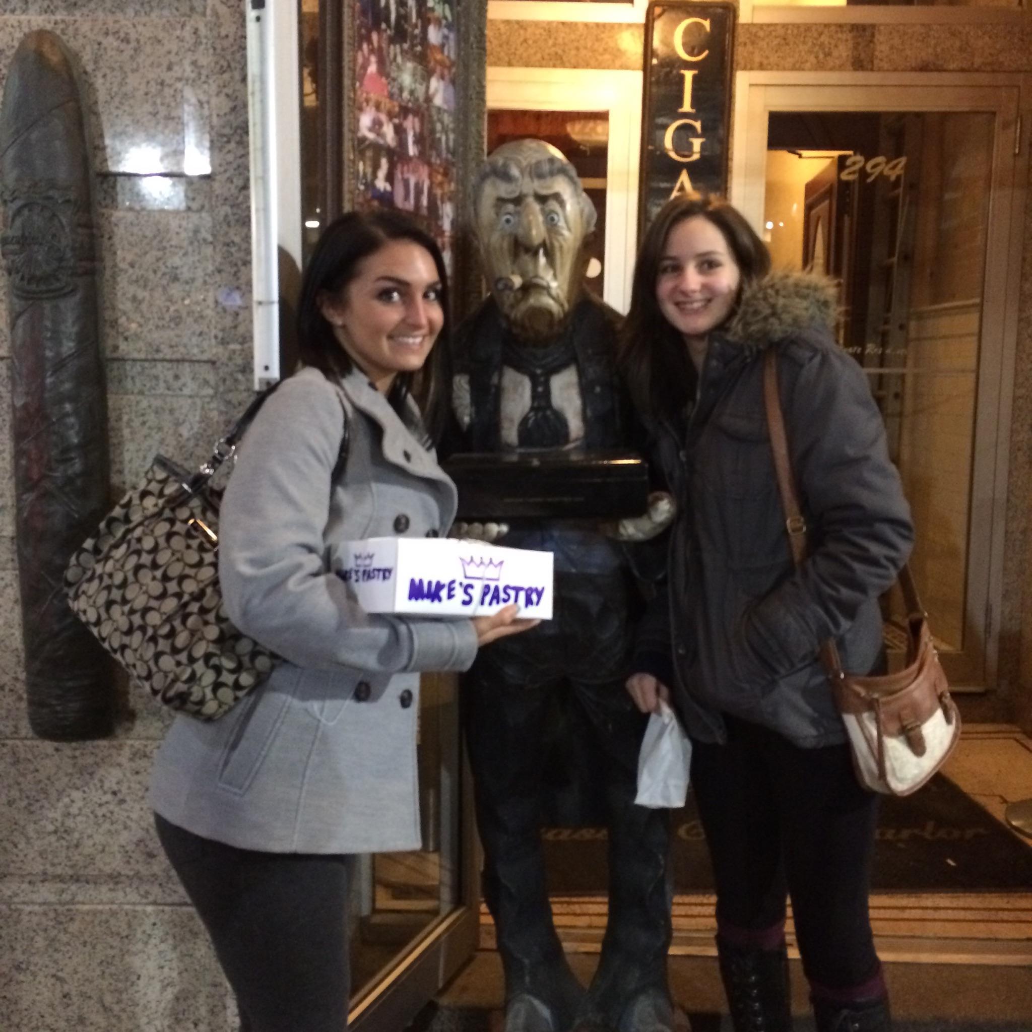 These are the faces of two adult women whose parents still can't resist making them take pictures with "handsome" statues