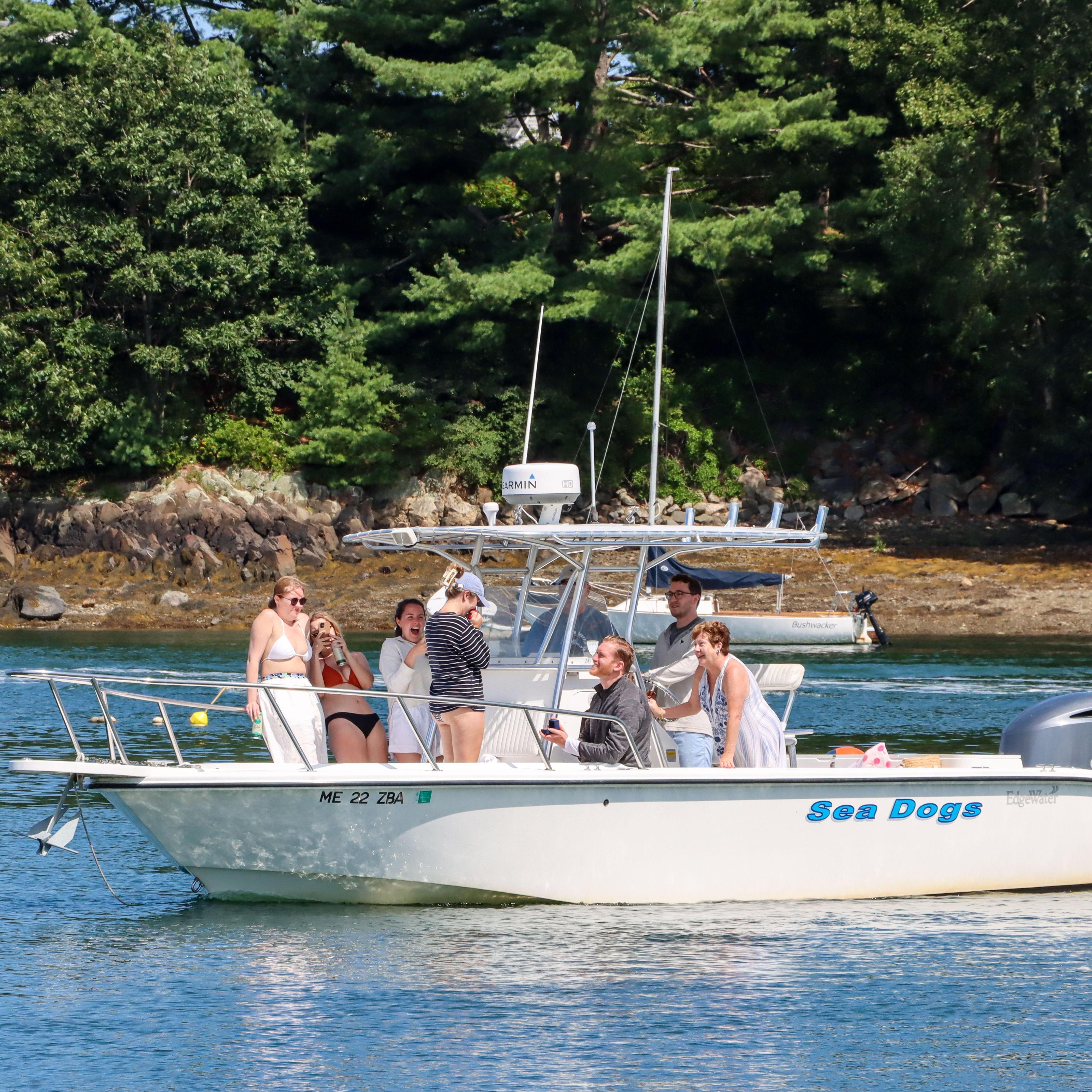The moment Bill got down on one knee after a fun boat day in Maine!