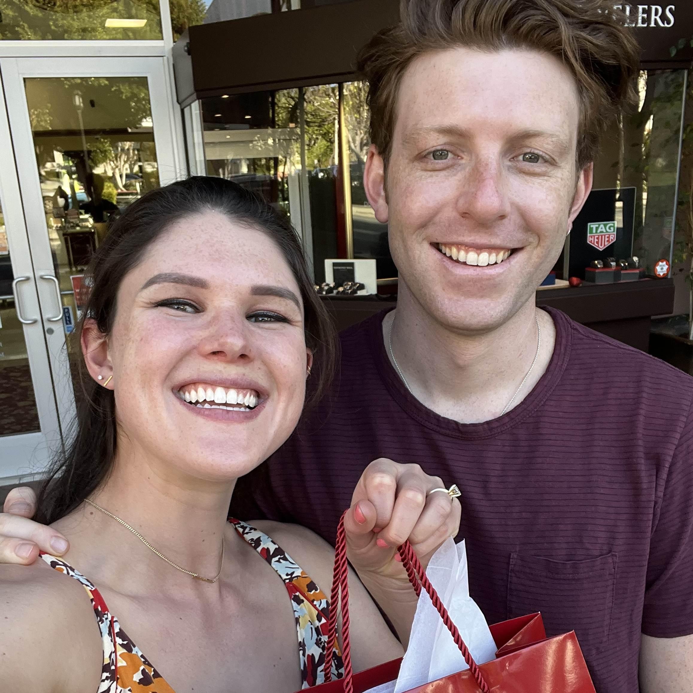 Big smiles after just buying each other wedding rings in February 2022. 