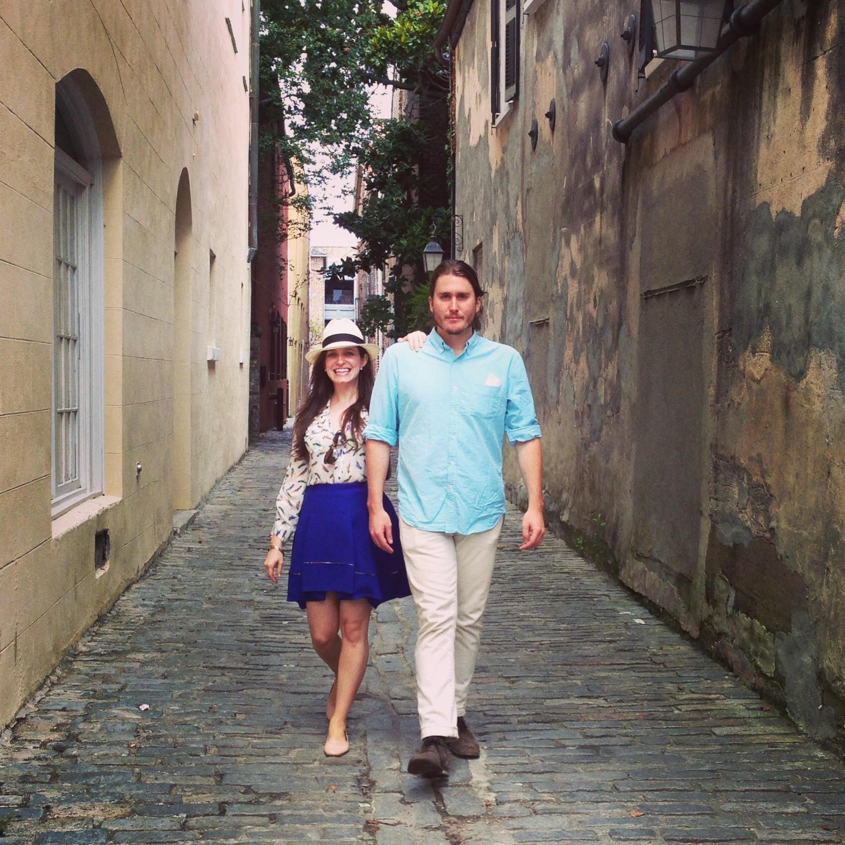 Jessica and Steve walking down a secluded street in Charleston. Jessica looking fabulous while Steve embarrassingly tries to look like an instagram model.
