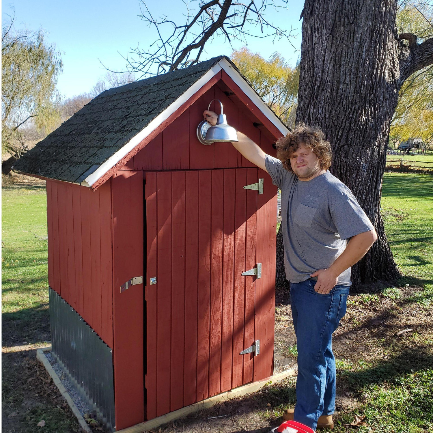 Tyler proudly showing off our newly restored outhouse turned garden shed in November 2022.