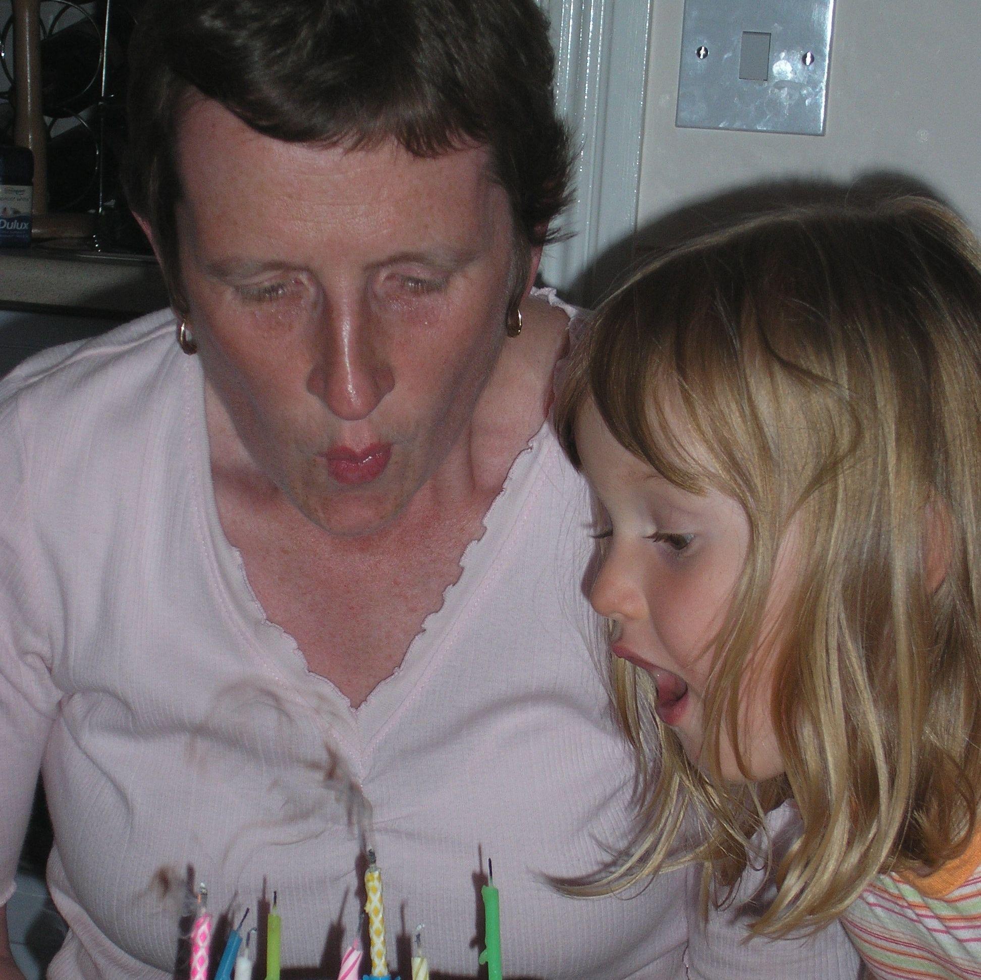 The bride & her aunt blowing out her aunt's birthday candles