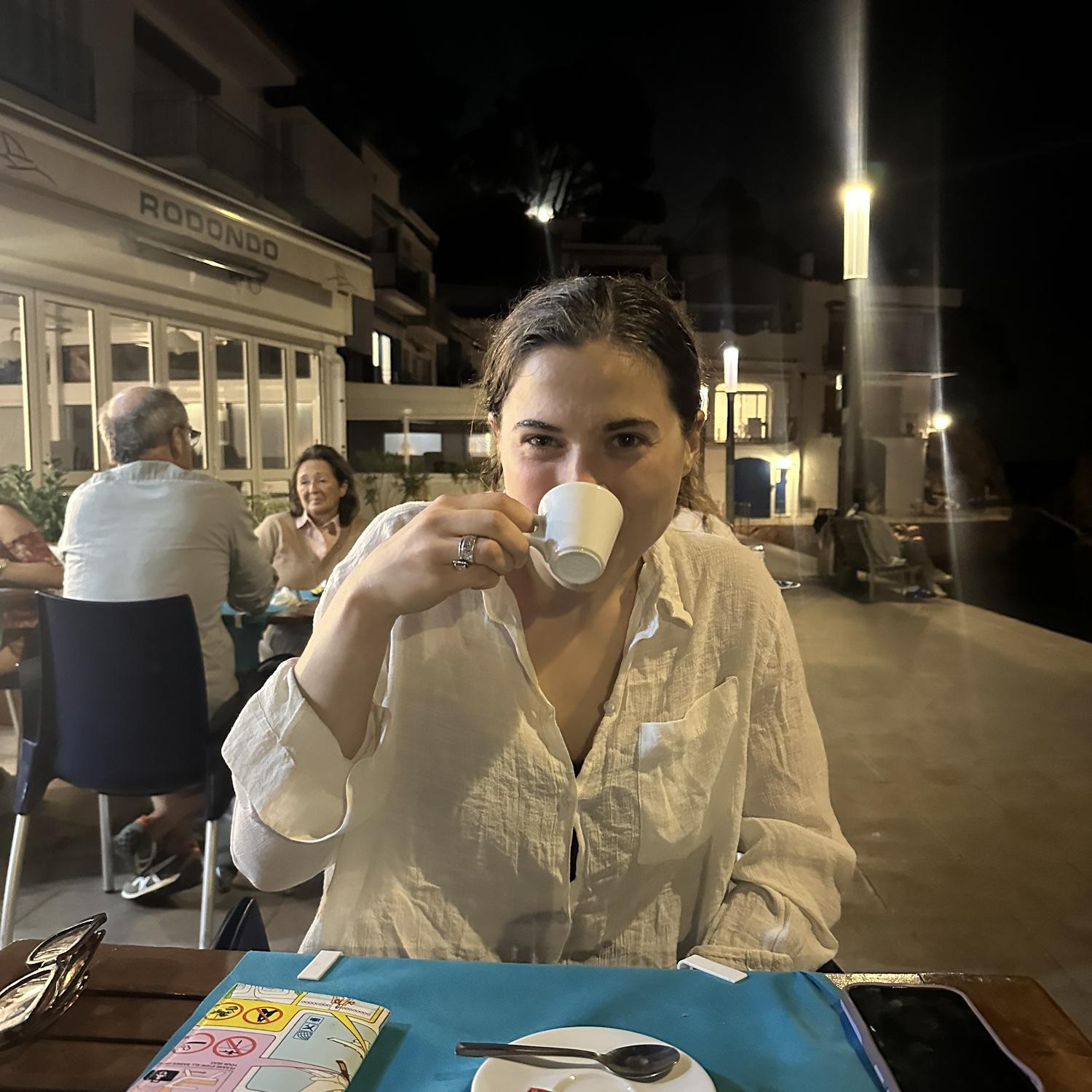 Emma drinking espresso in Tamariu, Spain