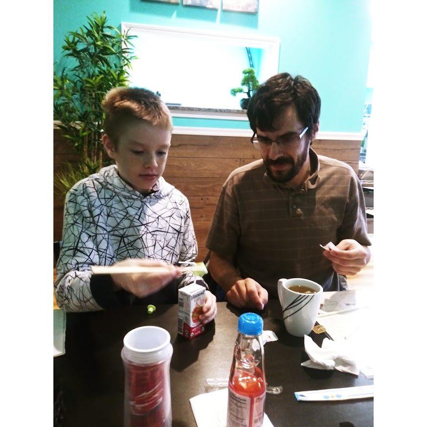 Brian teaching Dylan to use chop sticks