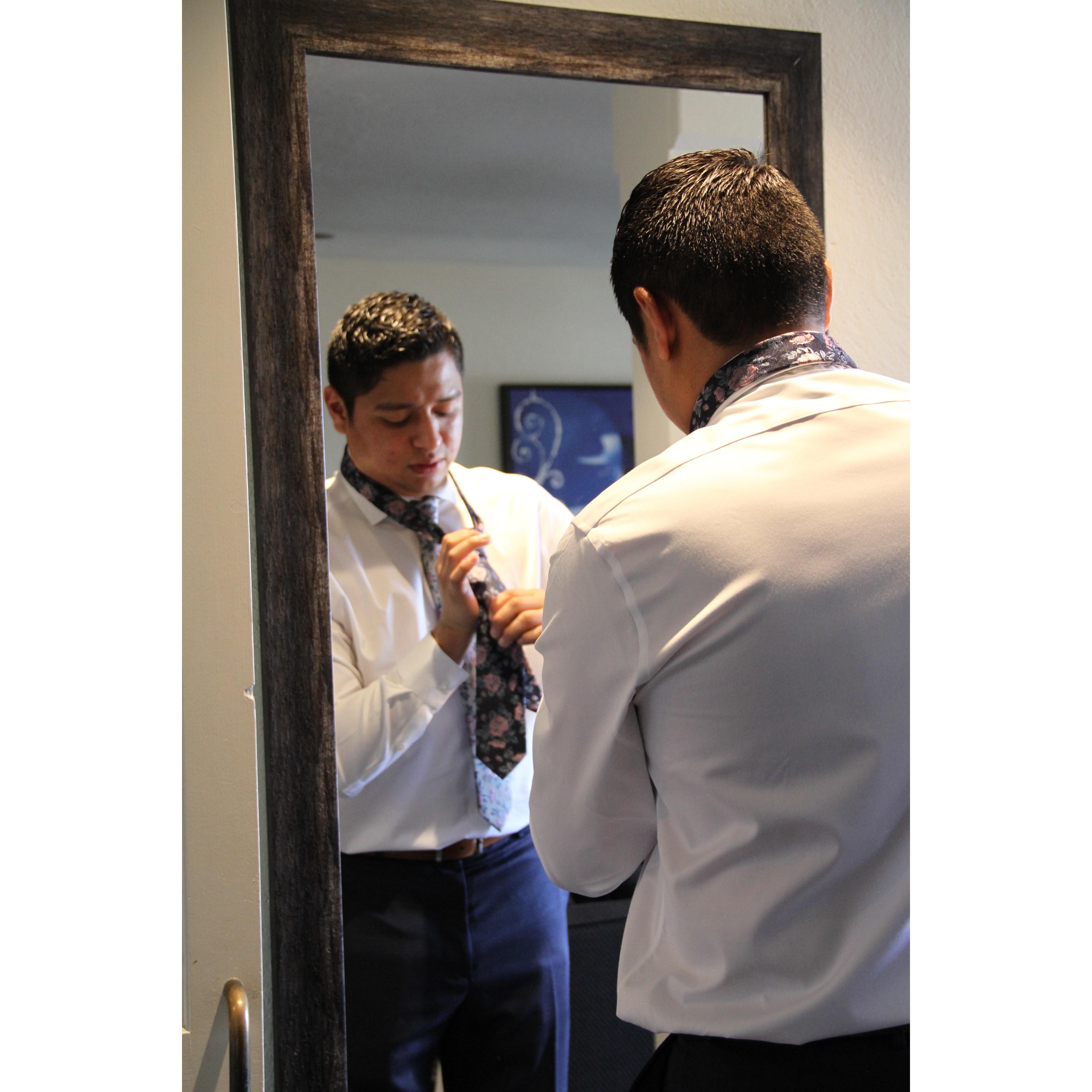 Groom tieing Best Man's tie before the ceremony