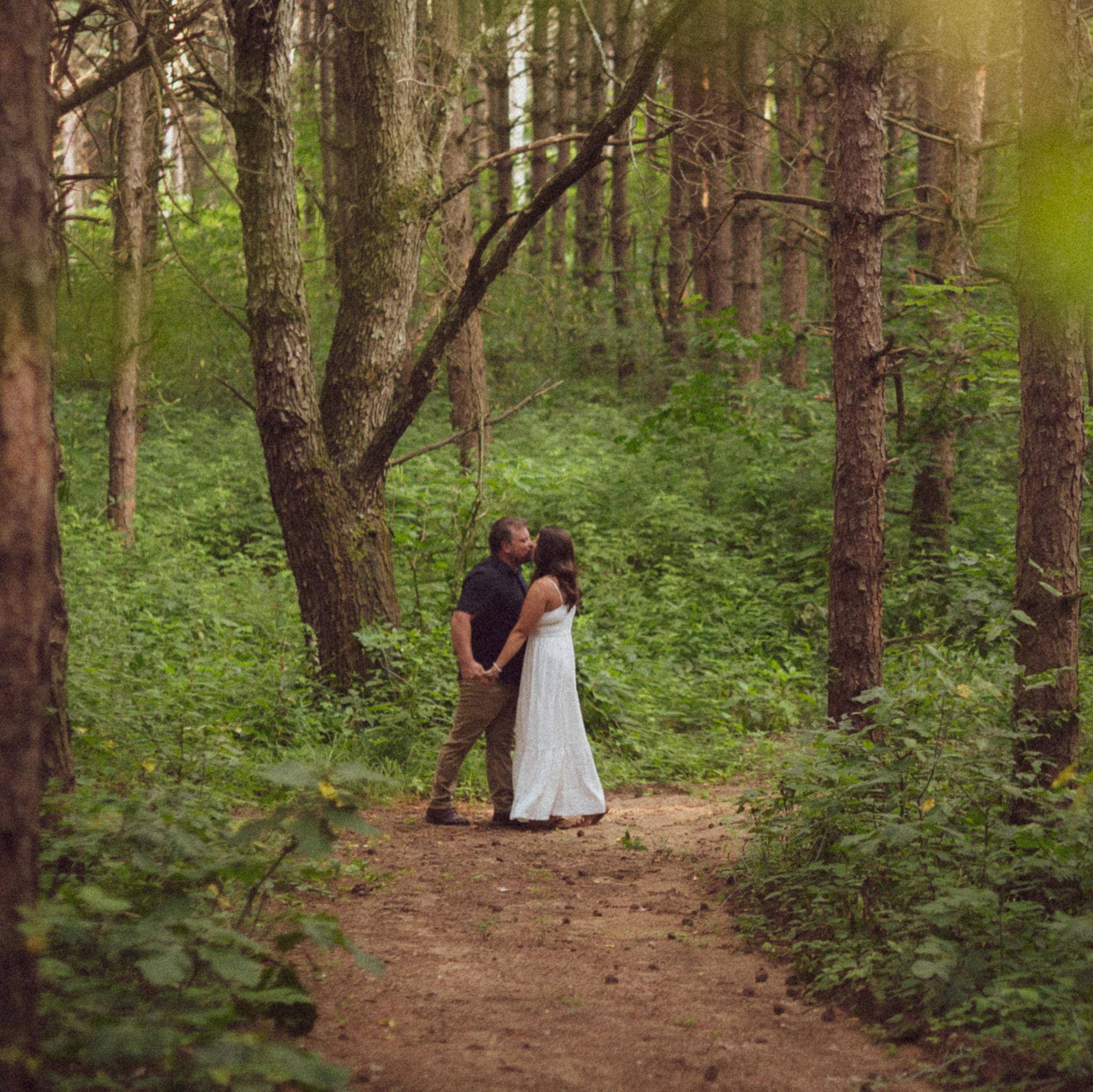 Jon and Cassidy in the pine trees during their engagement shoot.