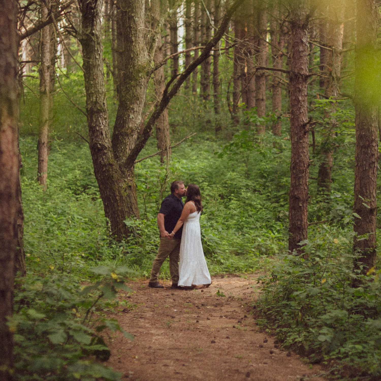 Jon and Cassidy in the pine trees during their engagement shoot.