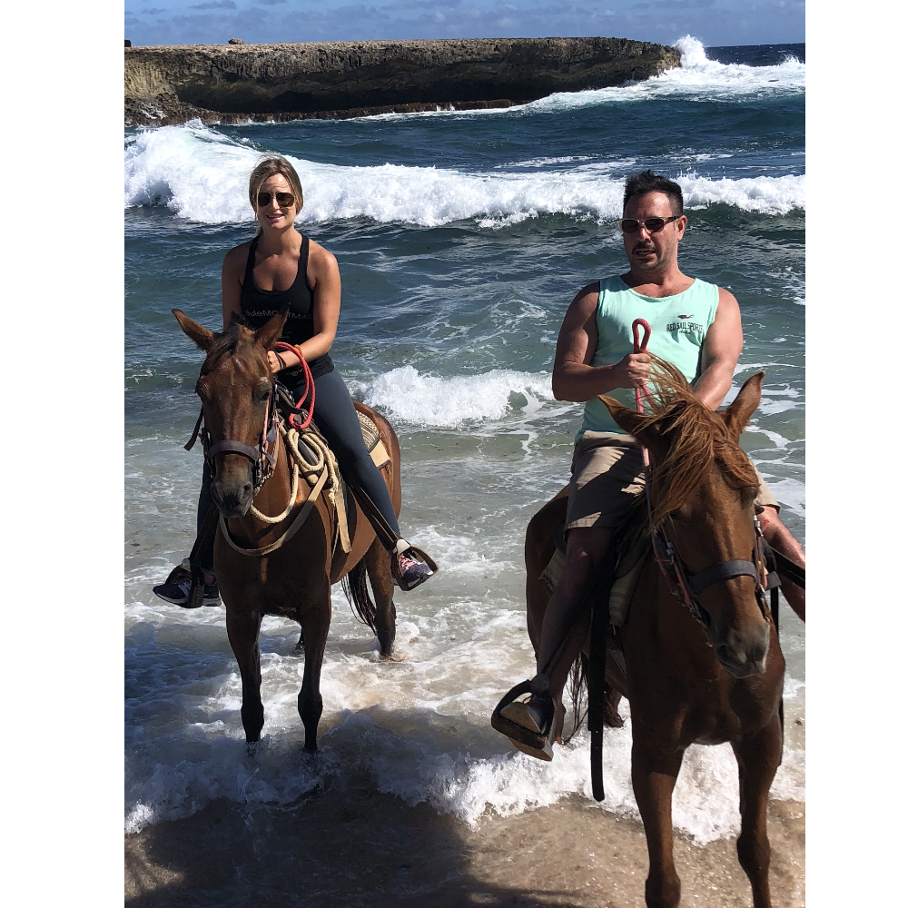Riding horses on the beach in Aruba. Mike's face says it all !!
