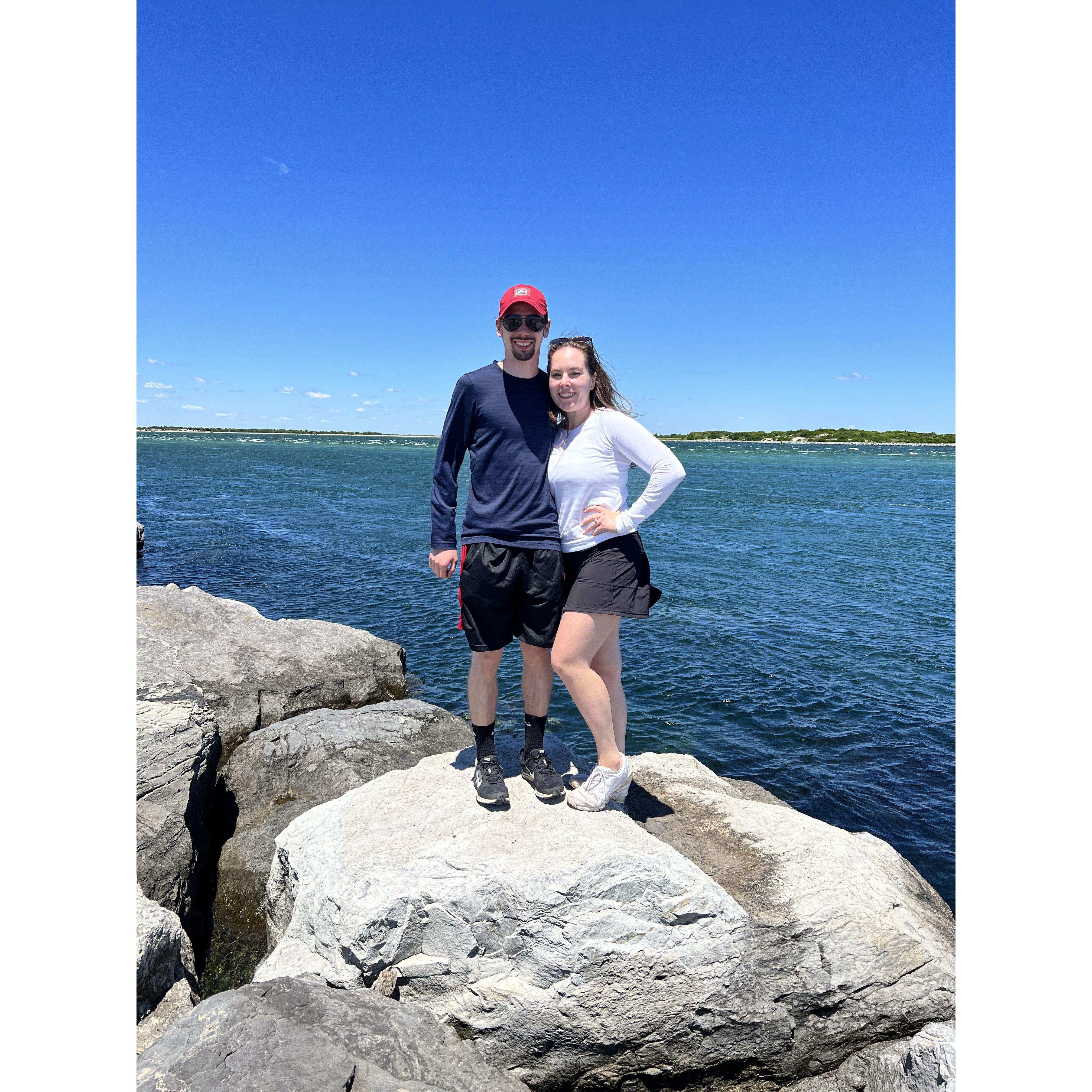 Olivia and Vince on the rocks in Barnegat Light in New Jersey in 2022.