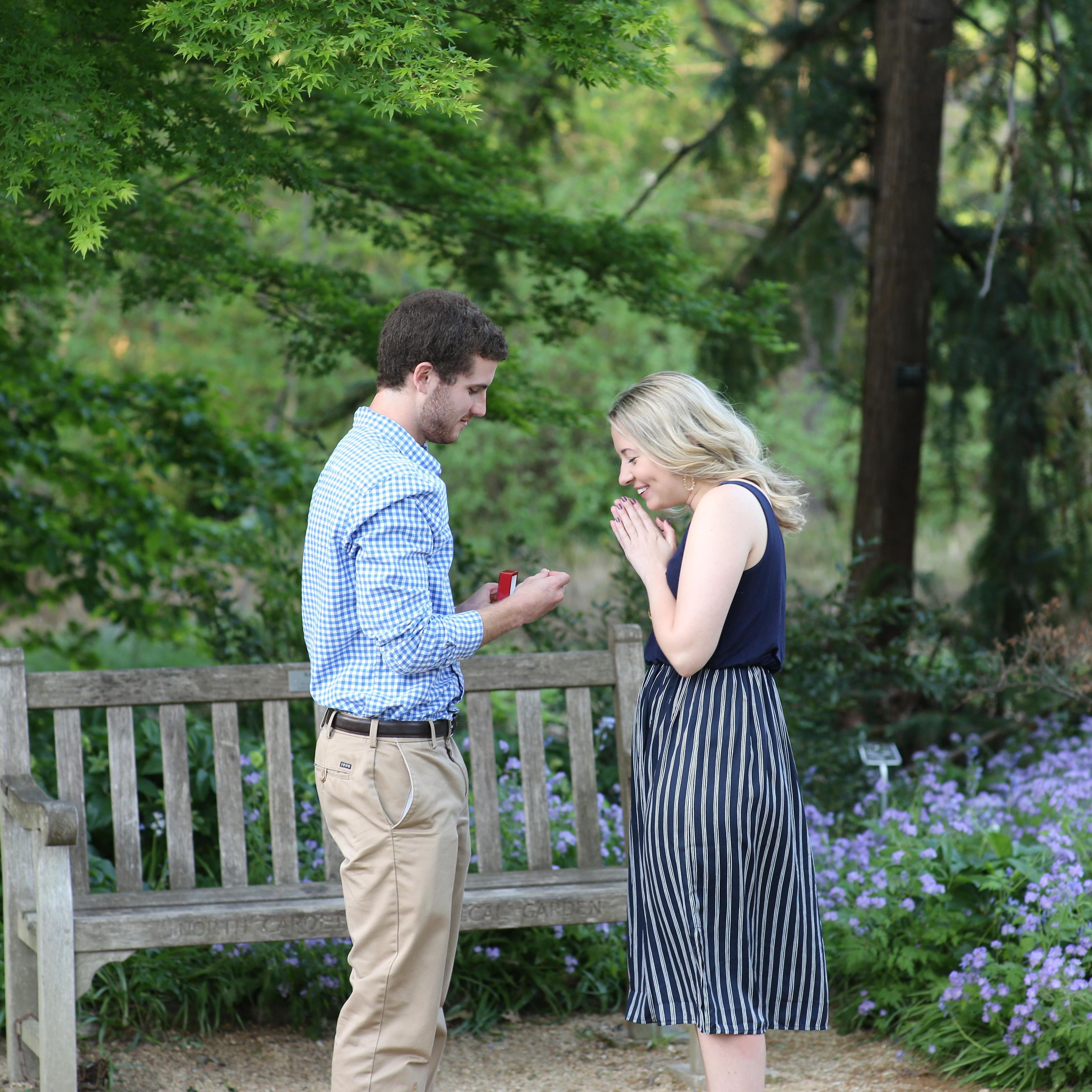James proposed in the Arboretum in Chapel Hill on my birthday! He had hidden the ring in the bush and whipped it out to surprise me. :)