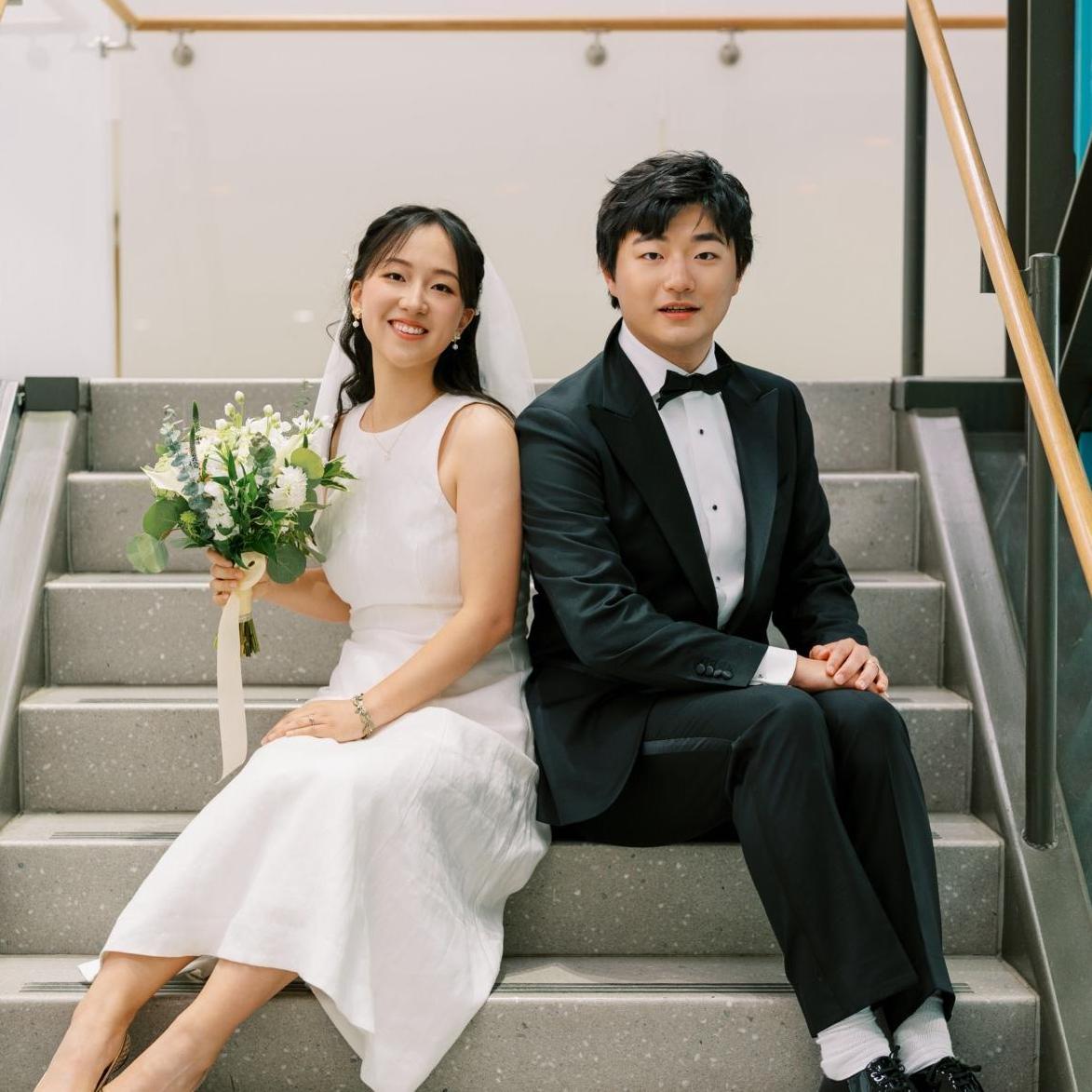 Two students seating on the stairs in student center