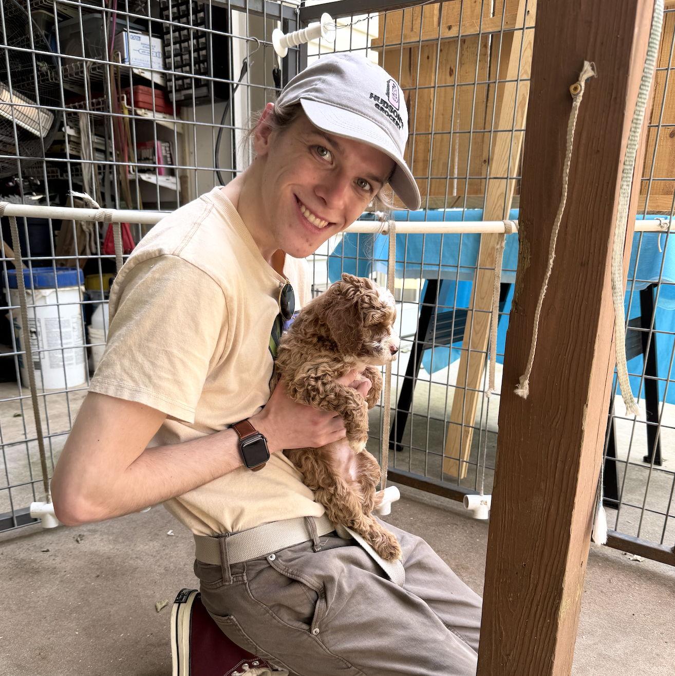 Nathan petting the neighbor's puppies