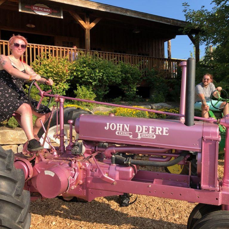 Anna and Marcel on tractors when Marcel visited in 2021