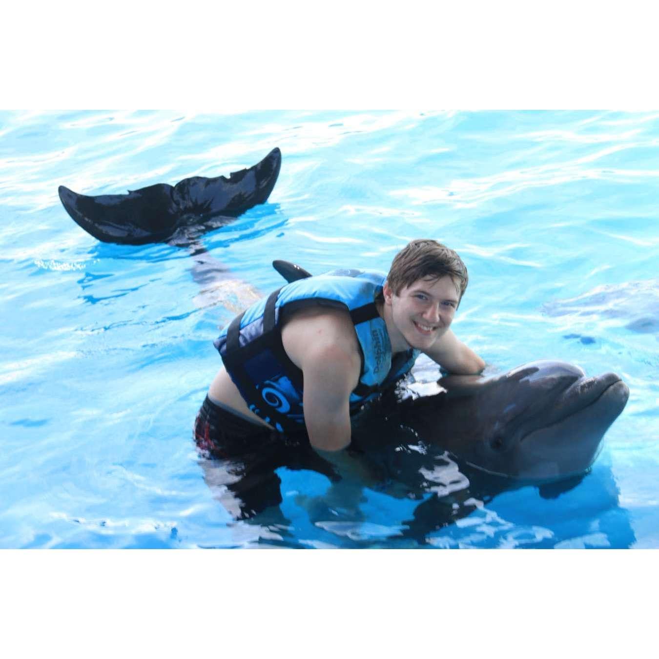 One of the many photos of Gage with a dolphin from our first date!