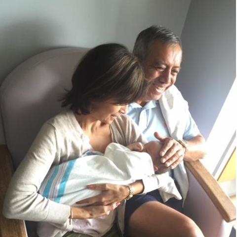 The groom's parents, Jackie and Carlos, with baby Harrison!