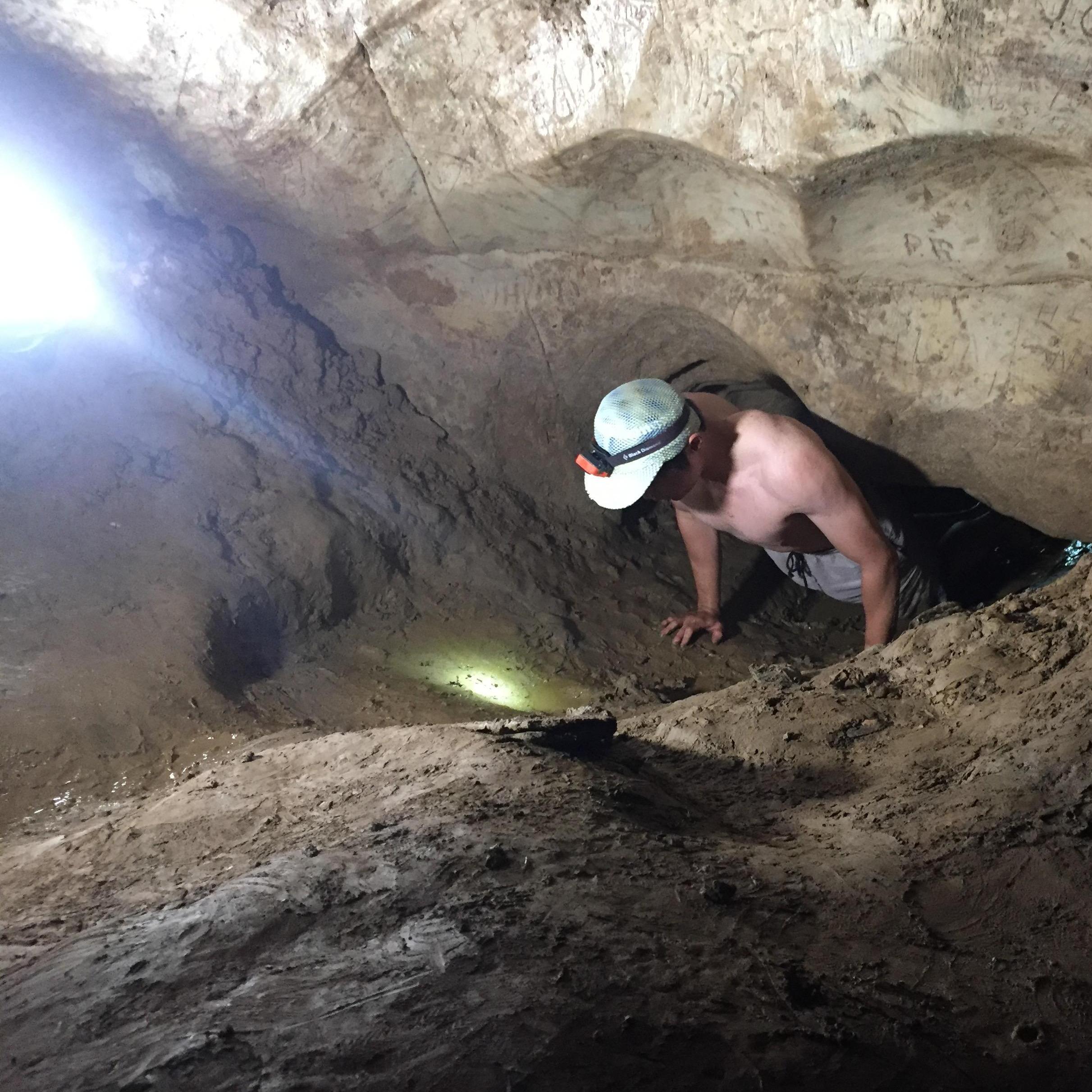 Yong: First time caving! Having hard time going through a tight space. We had to retreat after this photo because Josh found a "booger." Turns out the booger was a groundhog. (2017, Harrisburg, PA)