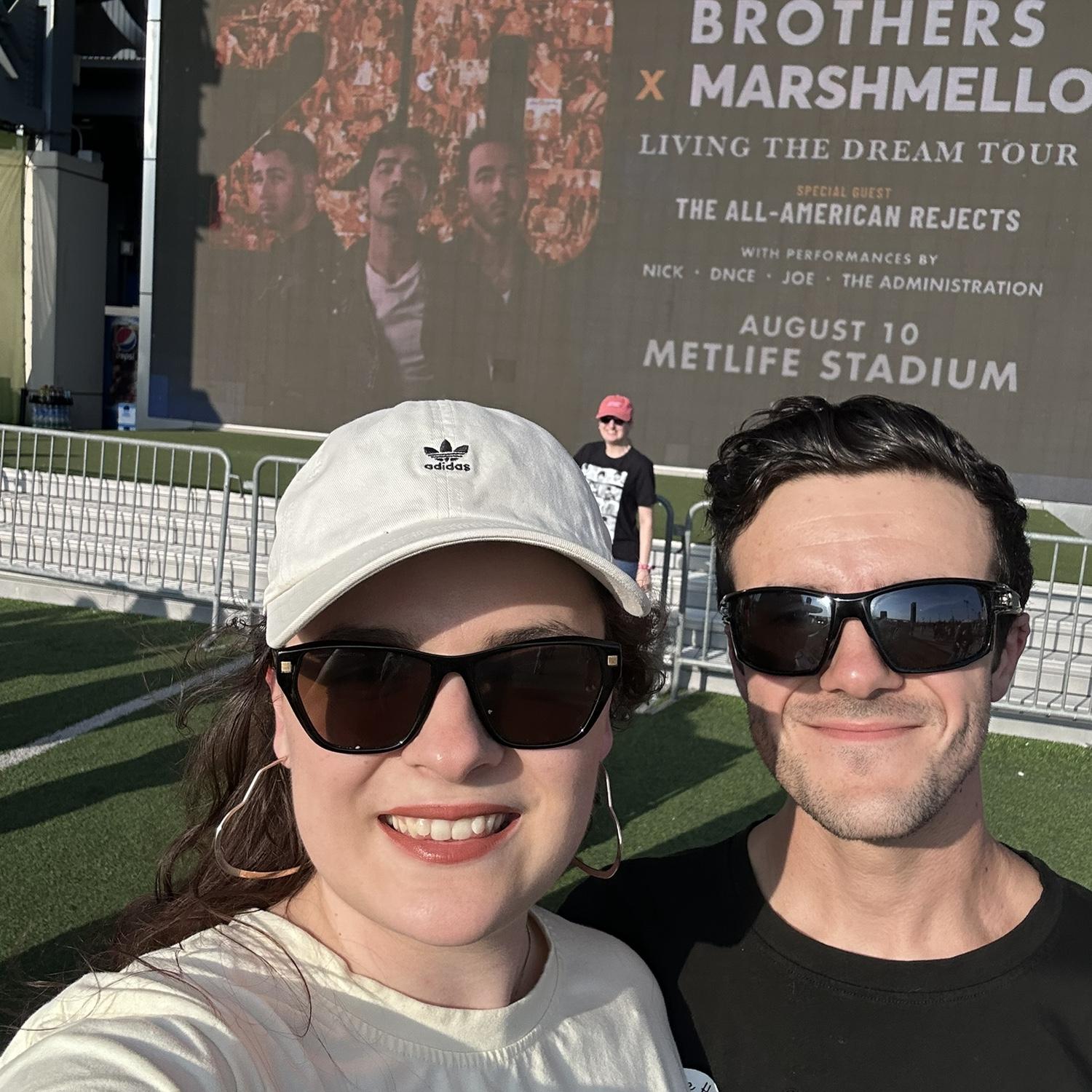 At the Jonas brothers concert Aug 2025! Our first trip post engagement.