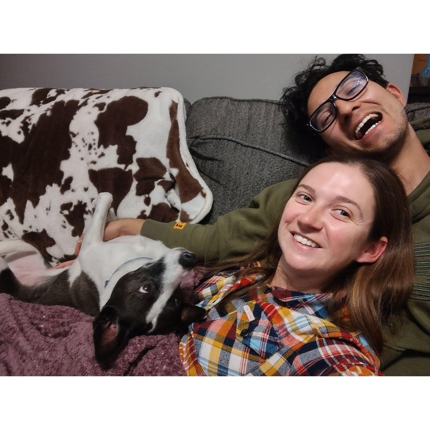 Family snuggles on the couch