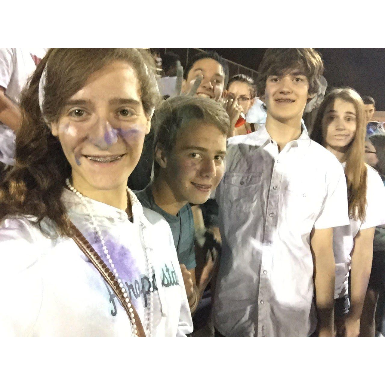 Sara, Jonathan, and Kyle at a high school football game freshman year