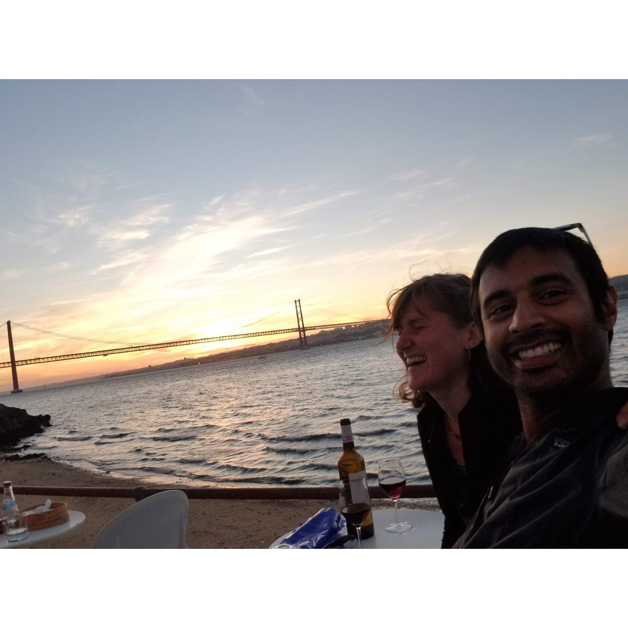 Zubair, making Alex laugh, while watching a romantic sunset in Lisbon, Portugal