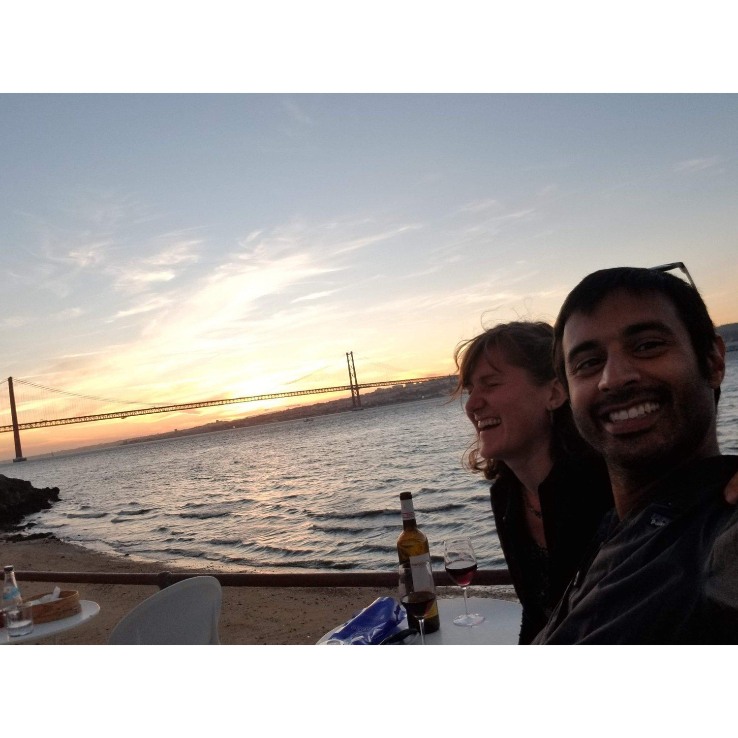 Zubair, making Alex laugh, while watching a romantic sunset in Lisbon, Portugal
