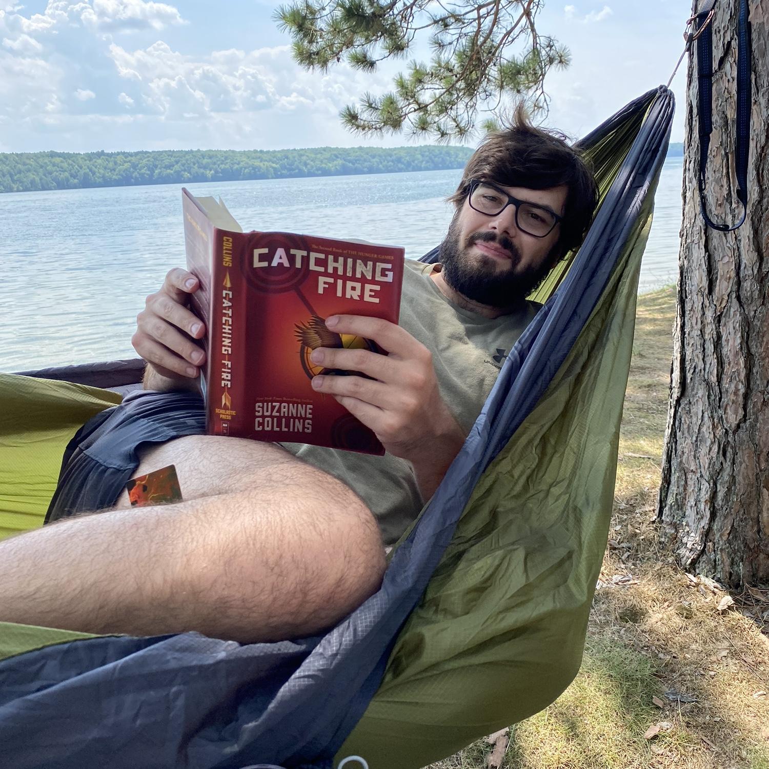 Dalton reading to Krista—one of their favorite pastimes—on the yearly camping trip in Mesick, Michigan, August 2023