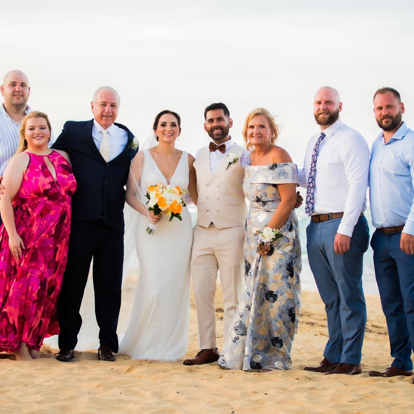 The bride and groom with the groom’s parents and siblings.