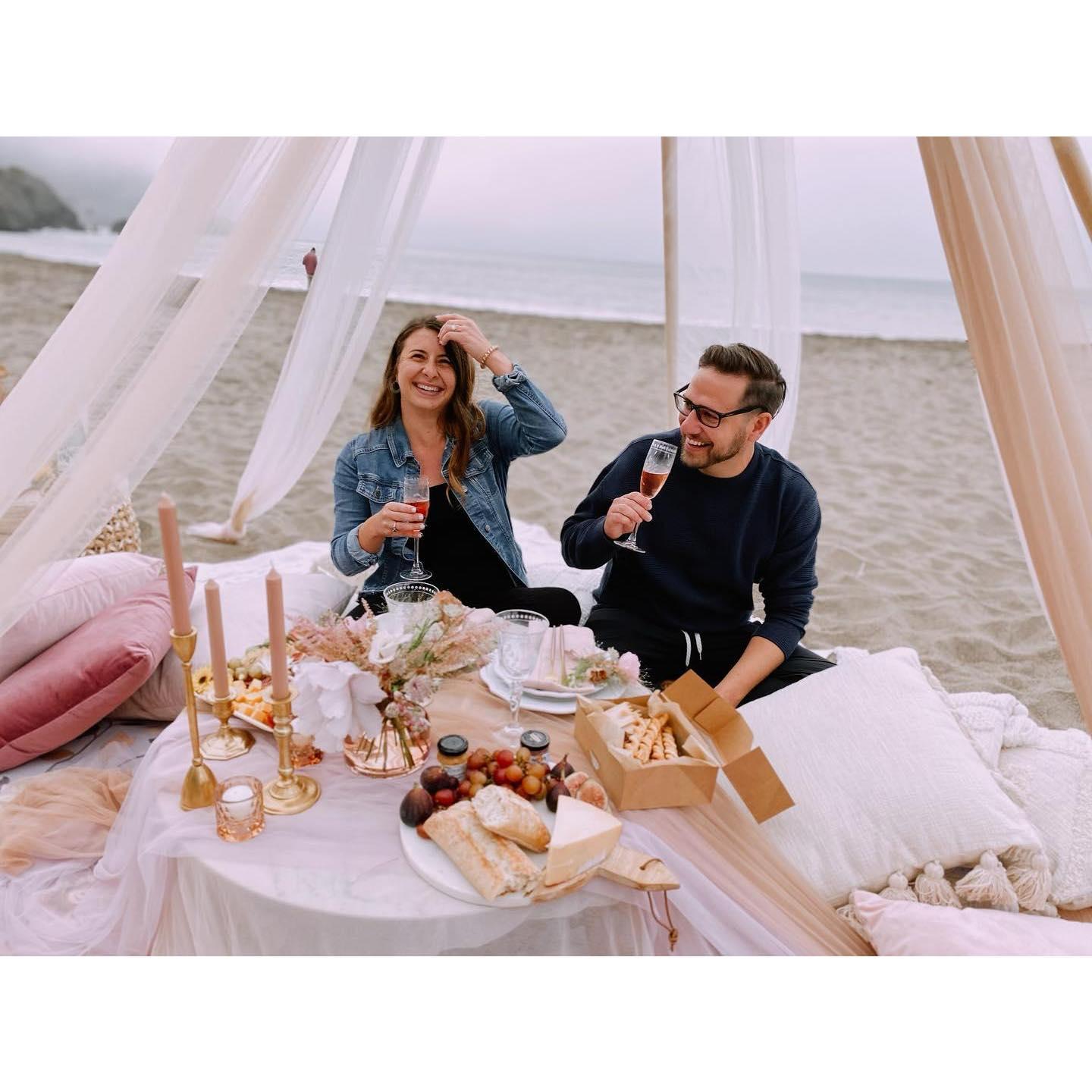 After 5 years together, Teddy proposed to Emma at Baker Beach in San Francisco! He coordinated a beautiful picnic on the beach with some of our closest friends!