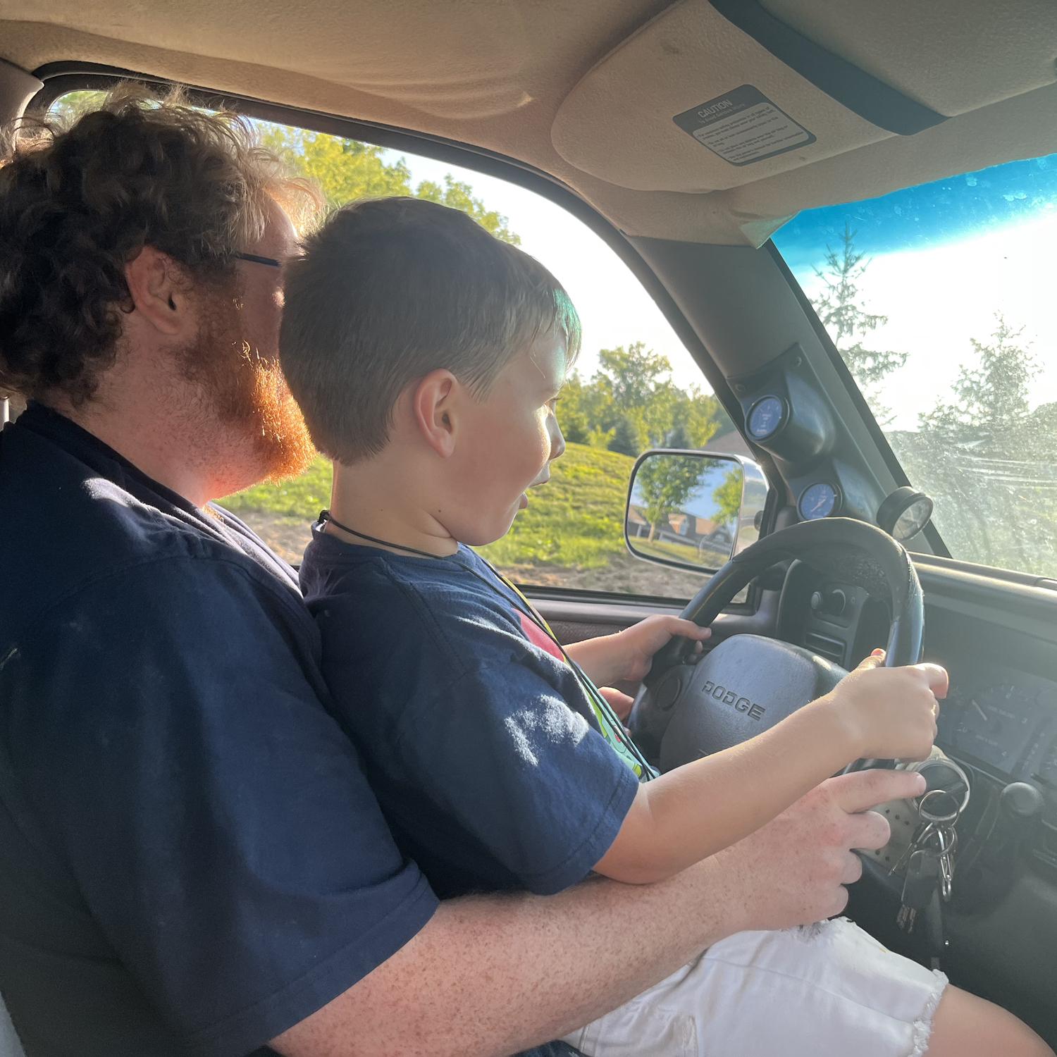 Zach and Aiden driving a block from the house