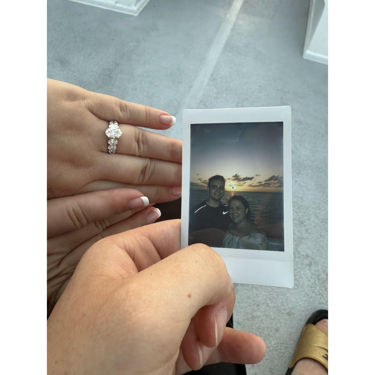 At our engagement party in the middle of a lagoon. We met really sweet honeymooners that took a polaroid of us with the sunset and gave it to us for our engagement.