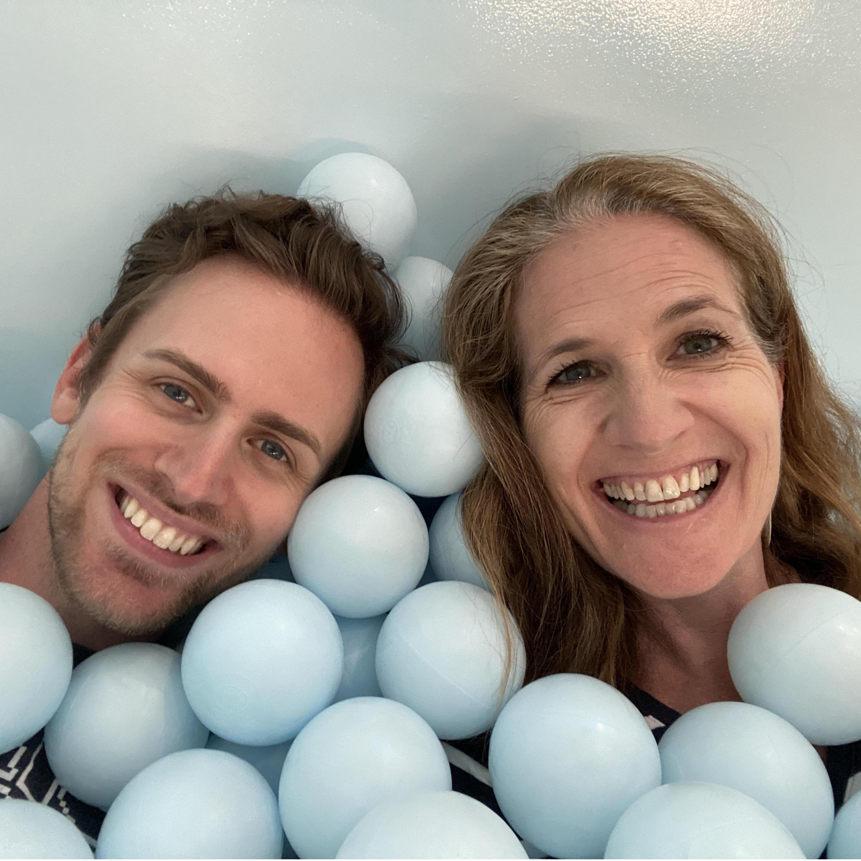 Submersed in the blue bubble balls at The Color Factory in NYC