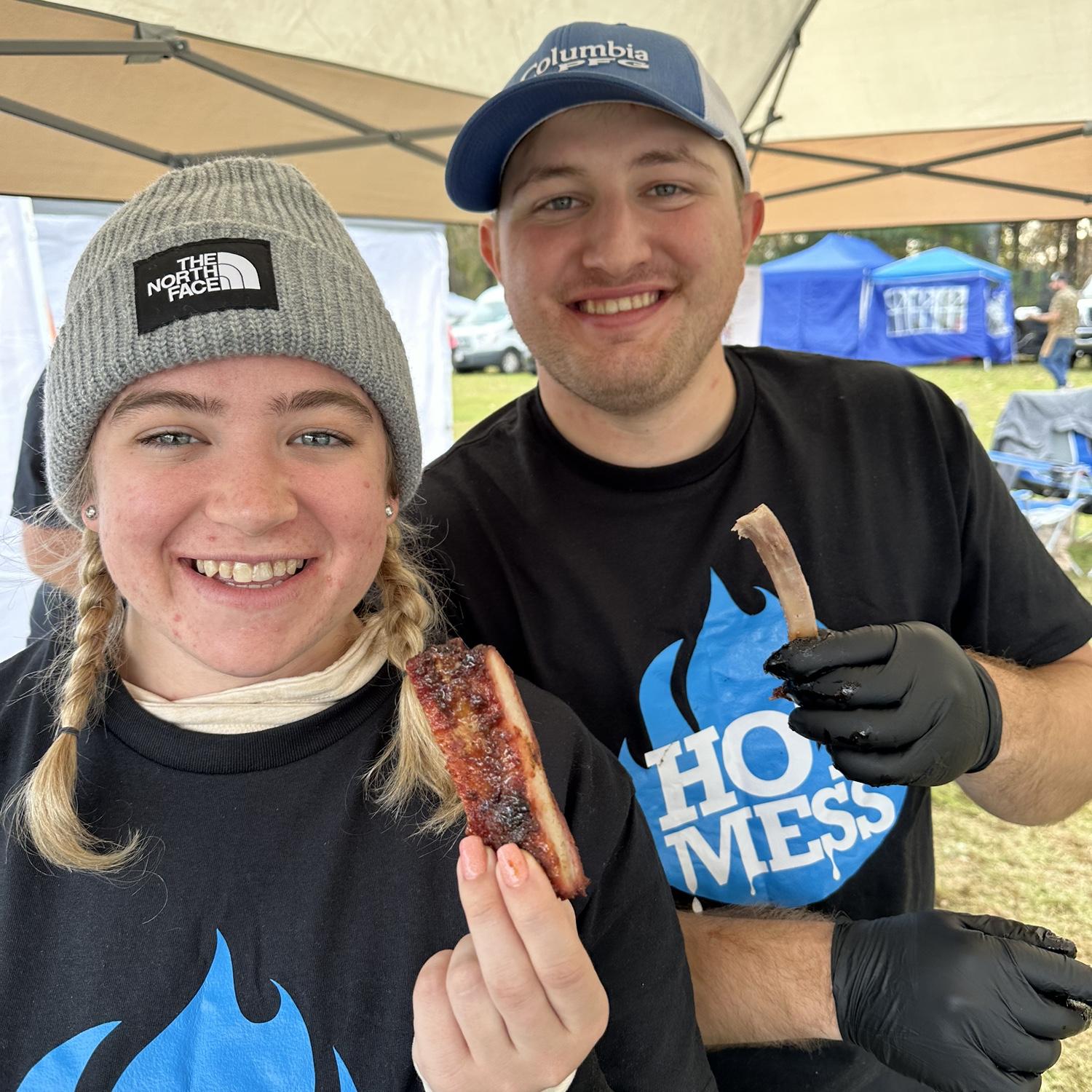 Jeremy and Hannah enjoying some ribs on the barbecue team.