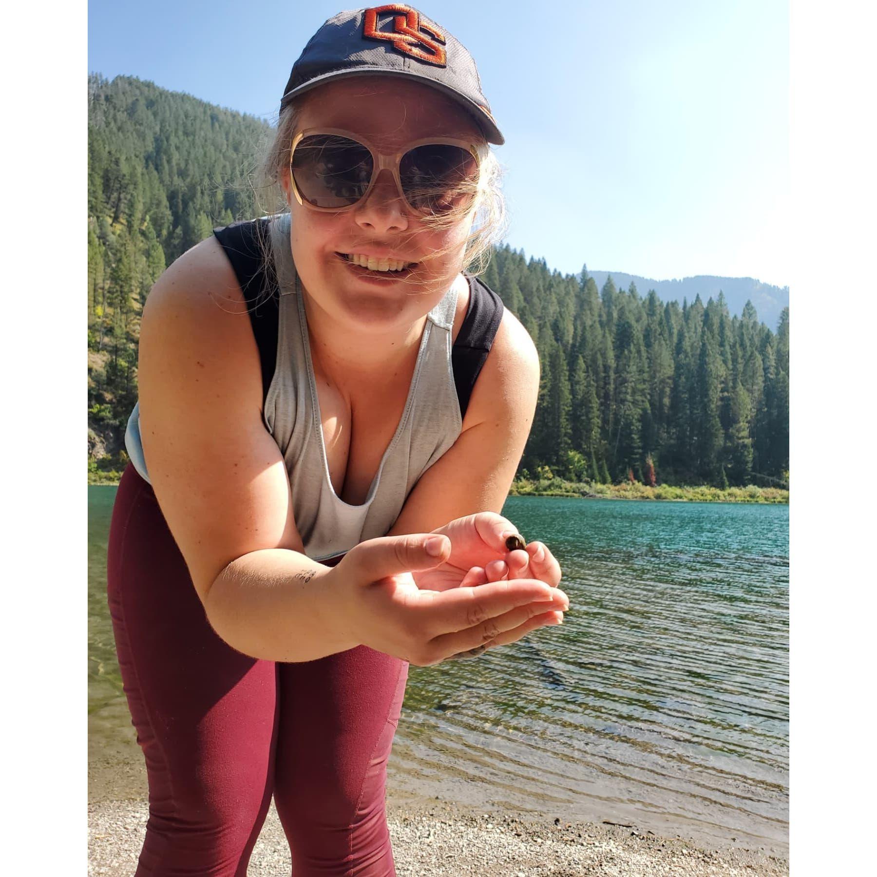 Lyndsey showing Drew a snail from the lower Palisades lake on their first hike out there.