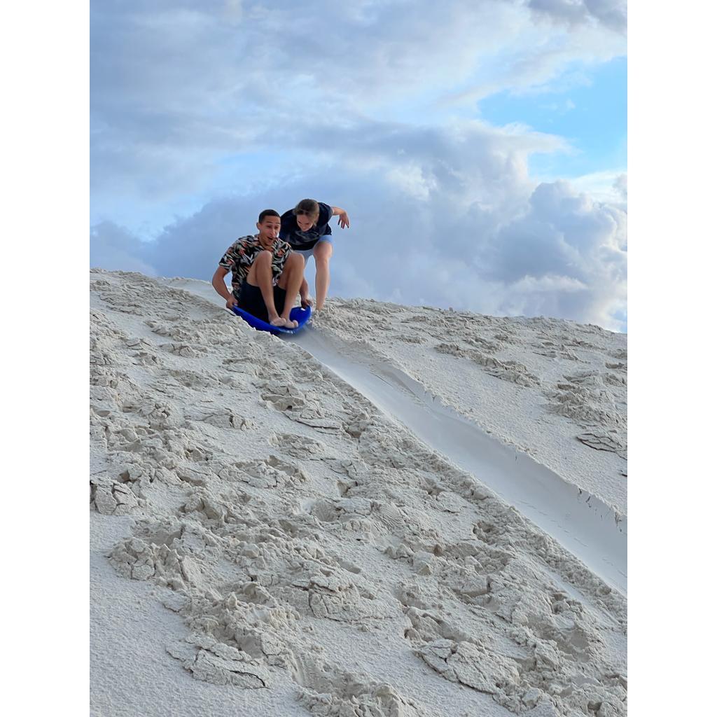 Pushing Ivan down a dune in White Sands