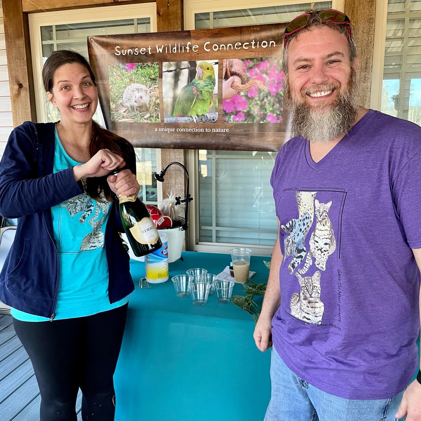 Margaret and Tommy pop champagne after their successful grand opening event for the nonprofit in January 2023.