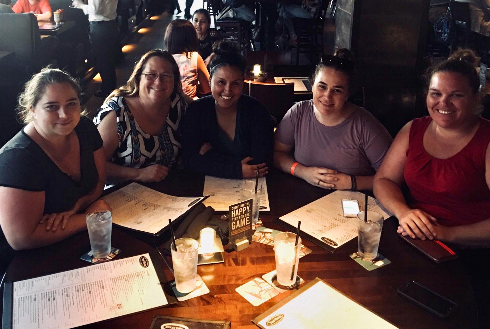 The bridal party celebrating after FINALLY finding the right dresses!
