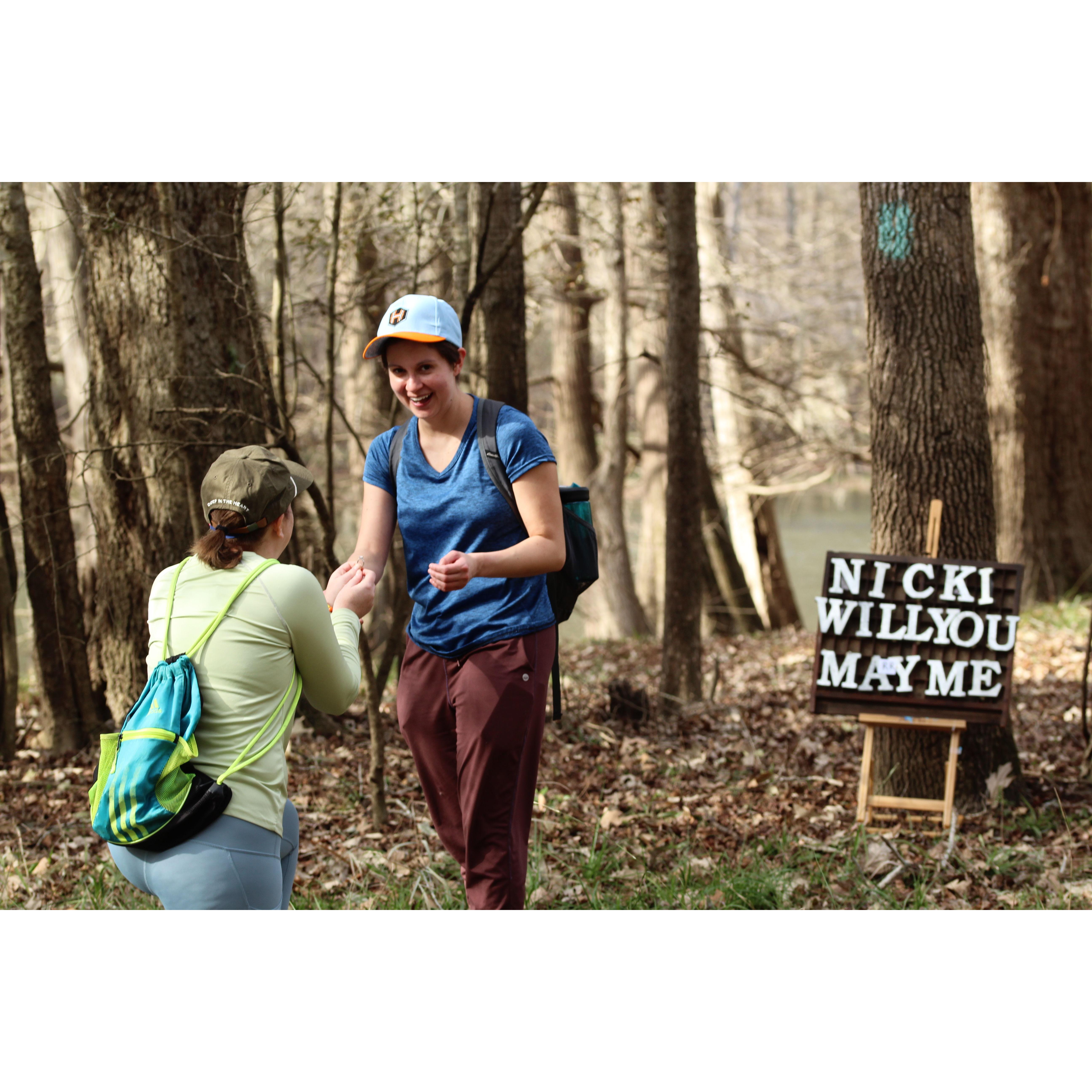 Suzanne proposed to Nicki along one of her favorite trails, with the assistance of Nicki’s friend, Kacie. Bonus points if you spot the missing letter(s) in the sign…