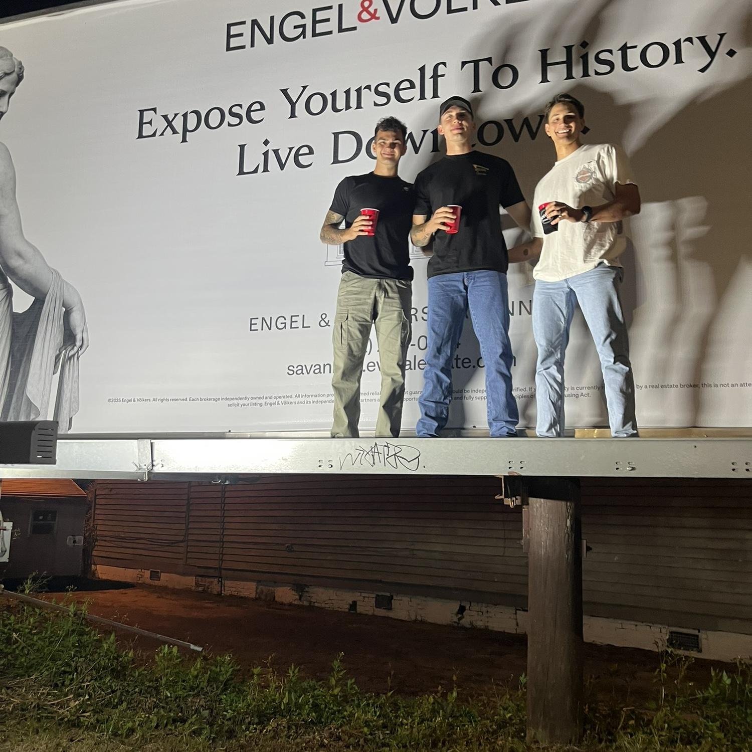 Boys being boys... Climbing on billboards!