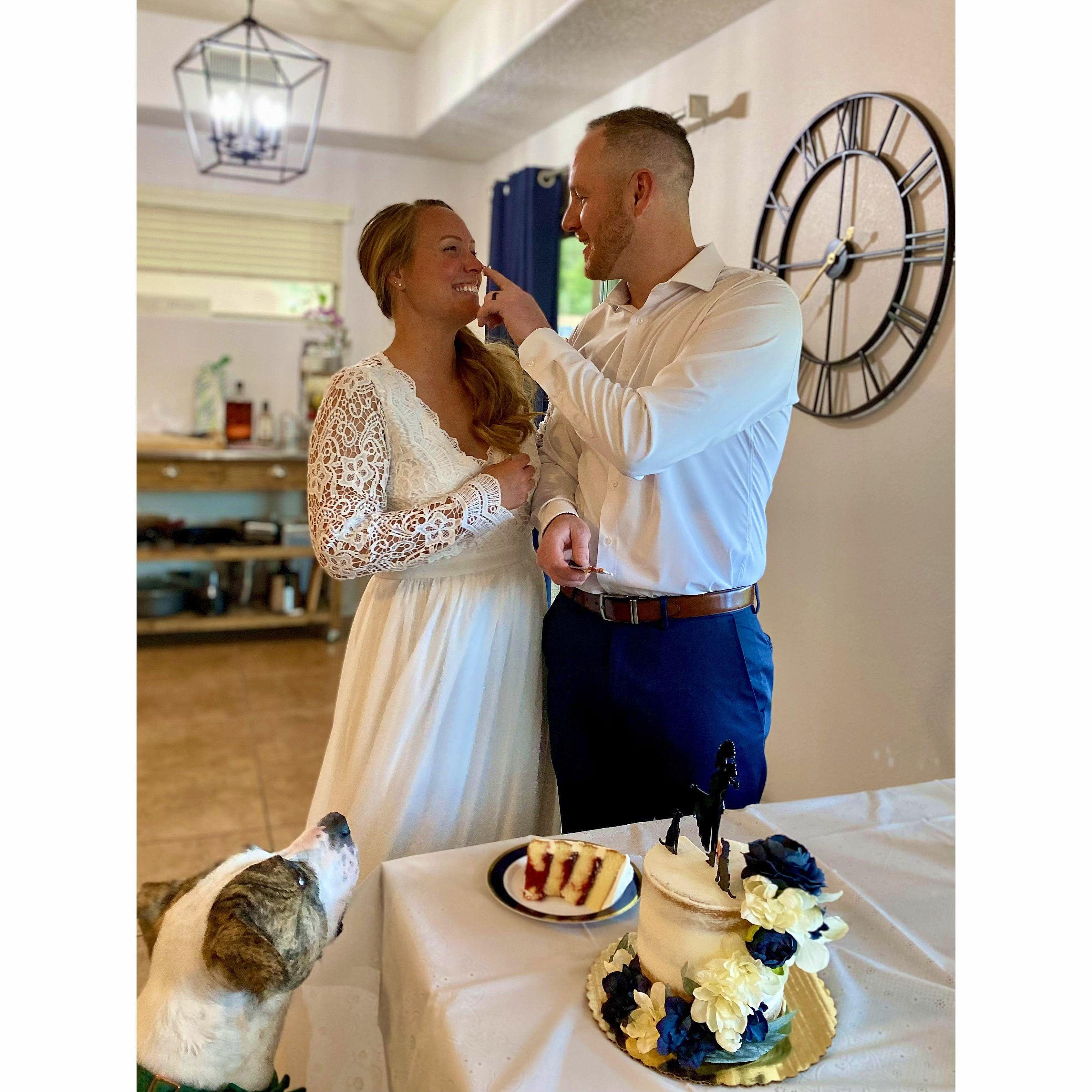 Cutting our wedding cake with Arnie waiting for a piece of cake