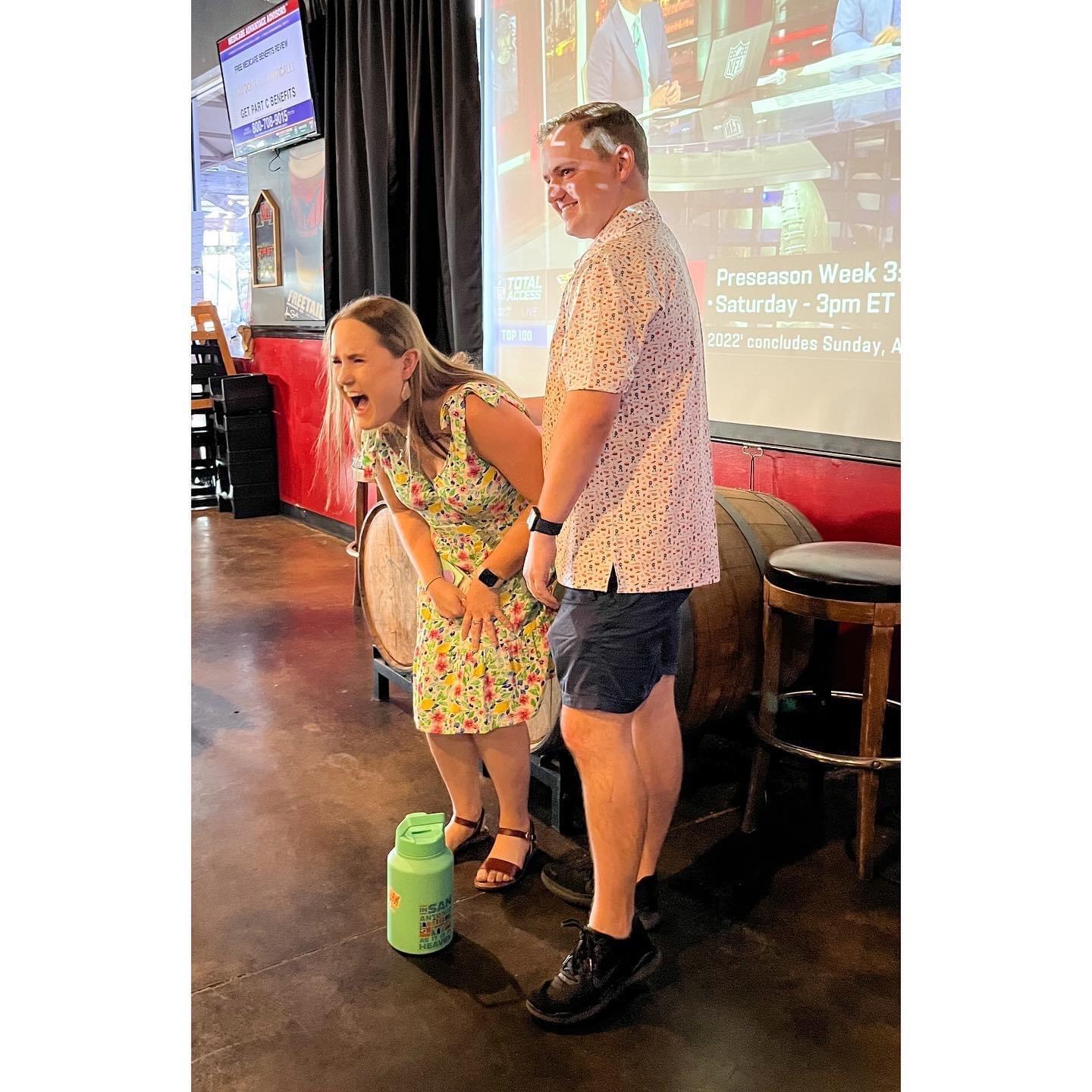 Camille saying yes to the proposal with her emotional support water bottle.