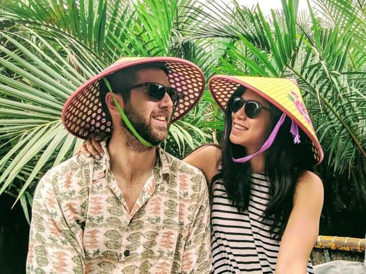 Playing tourists in a traditional fishing boat in Hoi An, Vietnam.
