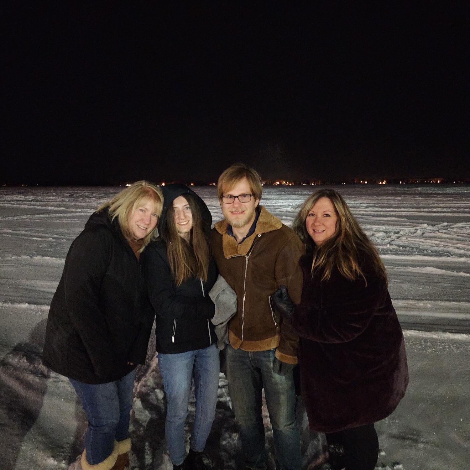 Standing on a frozen lake in MN with our moms 🥶