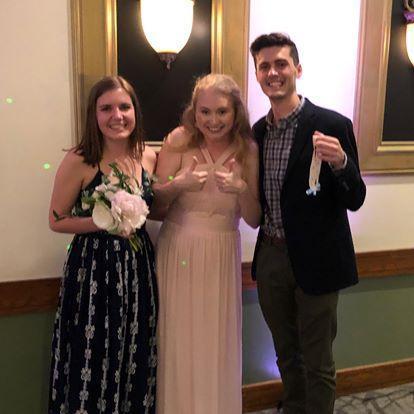 Catching the garter and boquet at the Jones' wedding (Christina may or may not have intercepted the bouquet from someone else)