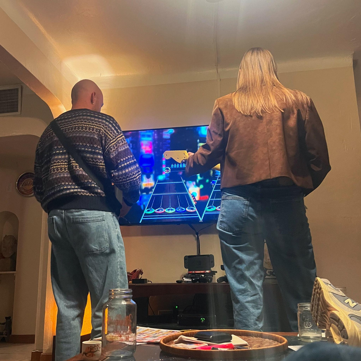 Cole teaching Bella his favorite game- Guitar Hero