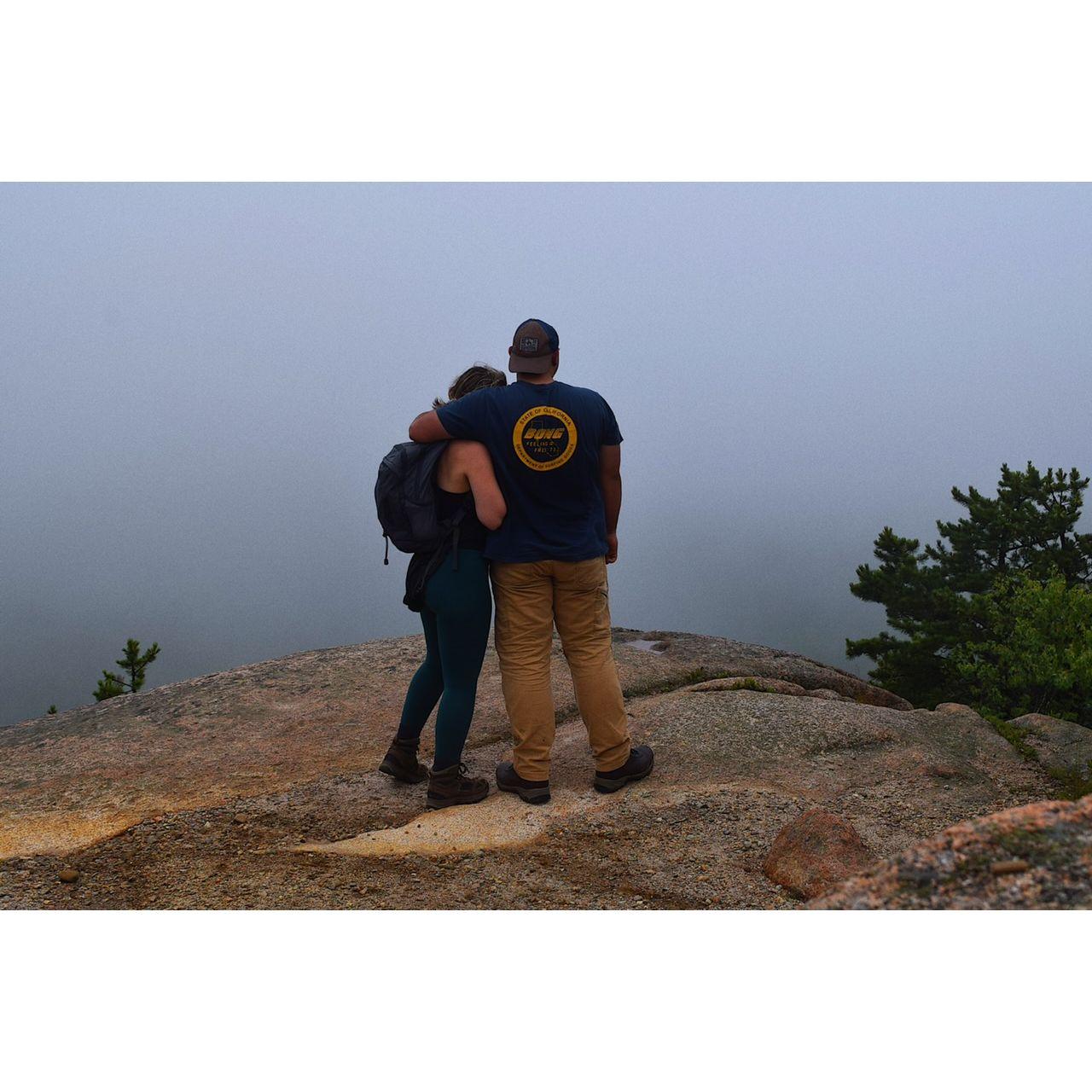 At the top of a very advanced hike Katharine insisted upon, they did it - but she cried and he laughed.