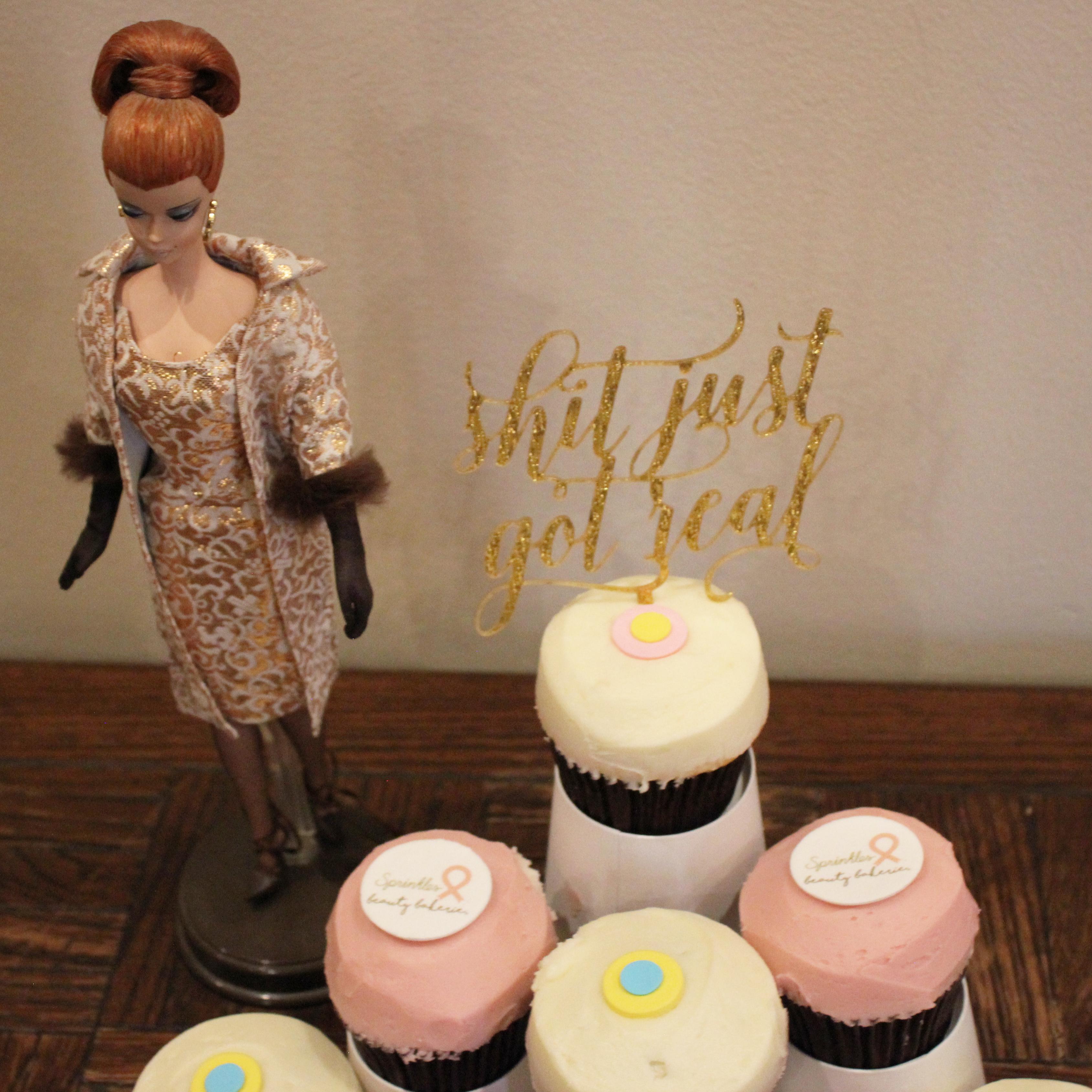 Keli's dress was based on this Barbie dress from the 1960s. And the cupcake topper says "Shit just got real," which we found appropriately romantic.